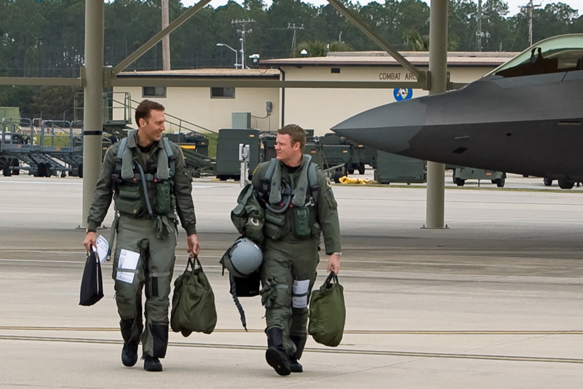 TYNDALL AIR FORCE BASE, Fla. -- Maj. David Pifferario, 302nd Fighter Squadron F-22 pilot, and Capt. Ryan Pelkola, a 90th FS pilot, step to their Raptors. The 3rd Wing and Air Force Reserve Command's 477th Fighter Group combined for its first F-22A Raptor deployment to Tyndall Air Force Base, Fla., for Combat Archer. The successful integration of both reserve and active-duty Airmen was showcased Feb. 2-17, when approximately eight aircraft and 132 Airmen took part in the Weapons System Evaluation Program training. Combat Archer is an assessment conducted to prepare and evaluate operational fighter squadron's readiness for combat operations. (Photo by Scott Wolfe)