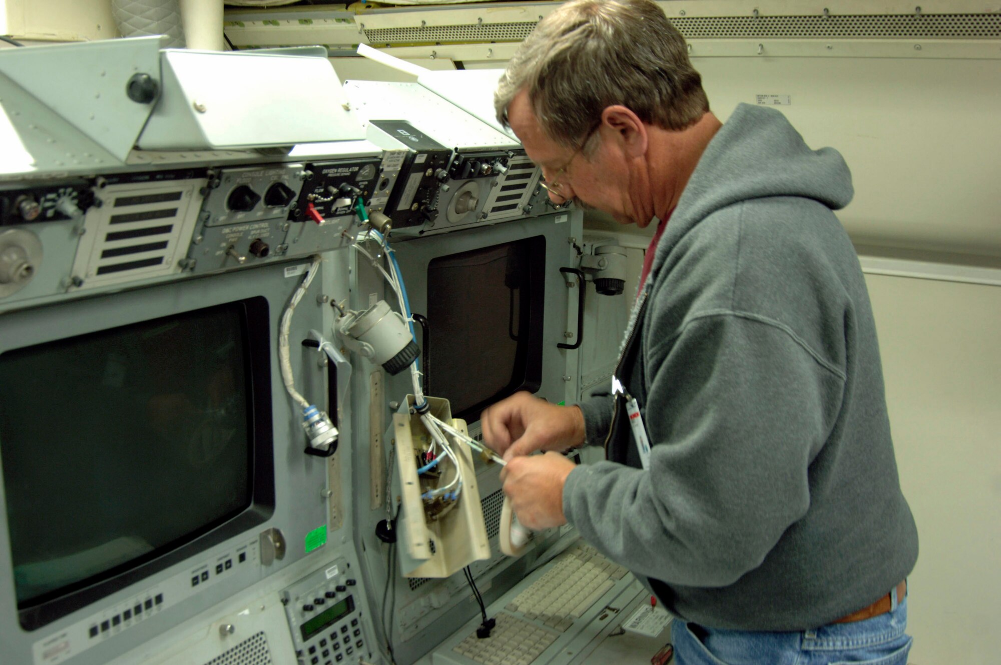 Bruce Wilbur of Northrop Grumman Corp. installs operator workstation interface equipment on an E-8C Joint STARS aircraft at Robins Air Force Base, Ga.  Officials at the Air Force Electronic Systems Center at Hanscom AFB, Mass., are managing the comprehensive upgrade, which will make beyond-line-of-sight communication possible, allowing Joint STARS to stand off further from fixed or mobile ground stations and increasing their range and coverage capabilities.  (U.S. Air Force photo)