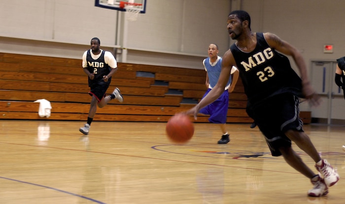 Medical Group player Kenton Waring dribbles down the court during the intramural basketball game Feb. 19 at the Fitness and Sports Center. (U.S. Air Force photo/Senior Airman Nicholas Pilch)  