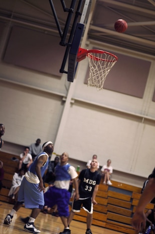Airmen from the medical group and operations group wait for a rebound off the rim after a missed basket during their intramural basketball game Feb. 19 at the Fitness and Sports Center. (U.S. Air Force photo/Senior Airman Nicholas Pilch)  