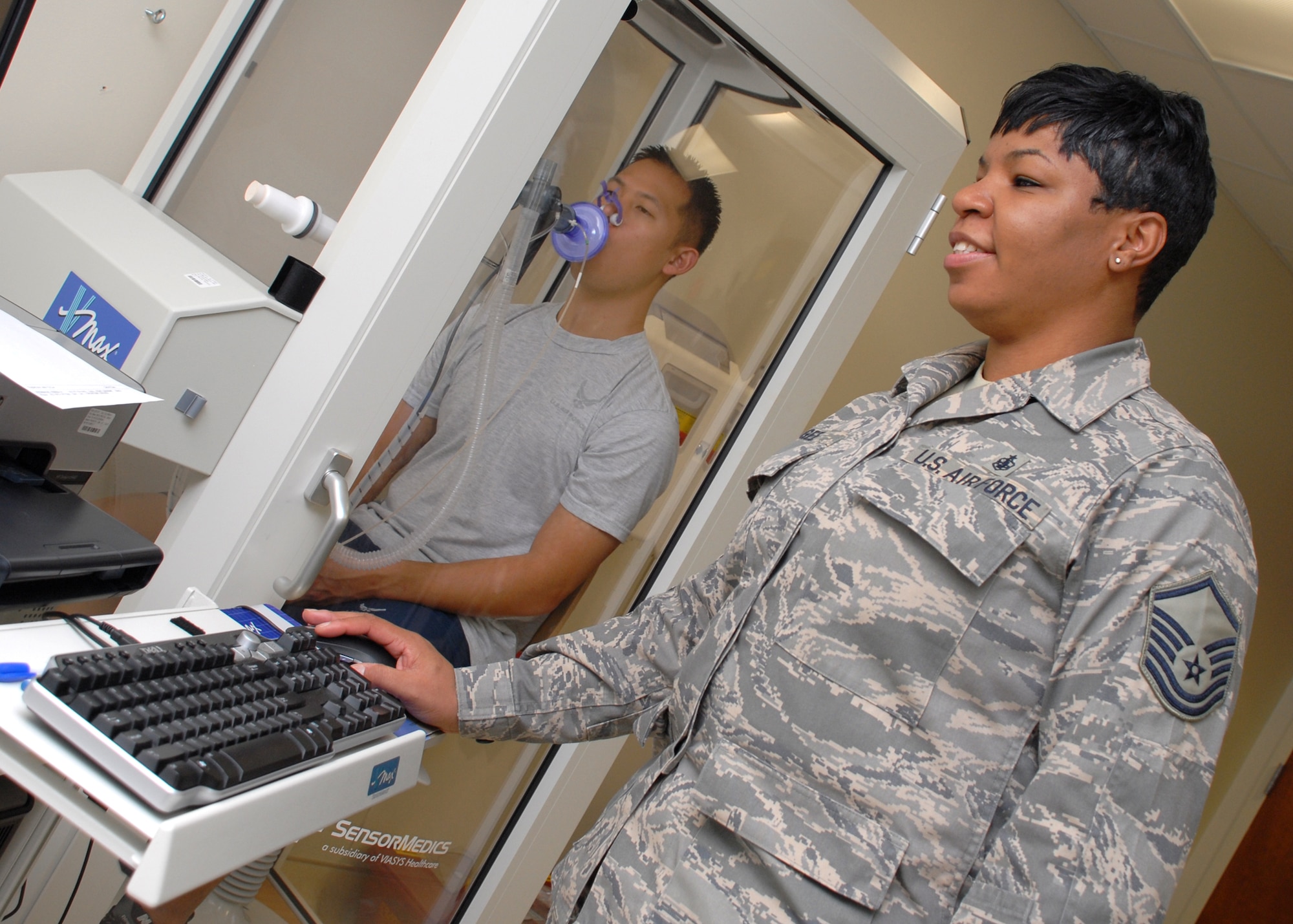 EGLIN AIR FORCE BASE, Fla. -- Master Sgt. Melissa L. Gee, 96th Medical Operations Squadron NCO in charge pulmonary diagnostic, conducts a lung capacity test on Senior Airman Yung Kim. Sergeant Gee was recently awarded the U.S .Air Force John Salustro Memorial Award for Cardiopulmonary Excellence. Among her many accomplishments, she procured the region?s sole cauterizing bronchoscopy machine, helping stop life threatening lung bleeds in three patients. Sergeant Gee graduated with an associates degree in Cardiopulmonary Laboratory Science and is working toward a bachelors degree in Health Sciences. She is an active member in a local Parent Teacher Association and participated in the American Cancer Society?s Relay for Life event. (U.S. Air Force photo by Staff Sgt. Mike Meares)