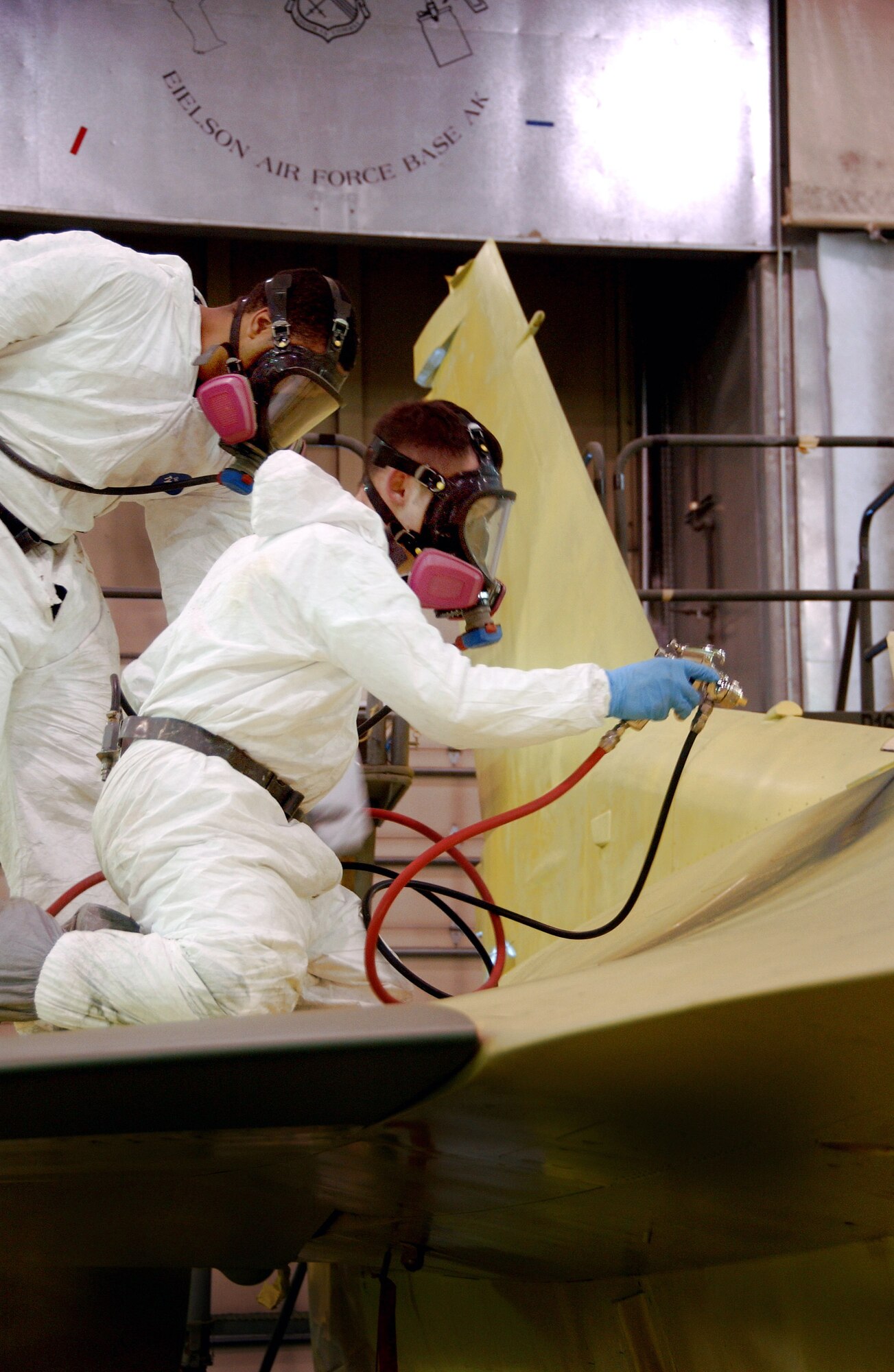 Senior Airman Frank Reardon and Airman 1st Class Eric Rickards paint an F-16 Fighting Falcon Feb. 14 at the corrosion facility. With the swap of the F-16s from Kunsan Air Base, South Korea, to Eielson AFB in support of their new mission as aggressors, each aircraft is applied with a scheme being Arctic Flanker, Blue Flanker or a Lizard Flanker. Airmen Reardon and Rickards are 354th Maintenance Squadron sheet metal workers. (U.S. Air Force photo/Airman 1st Class Christopher Griffin)