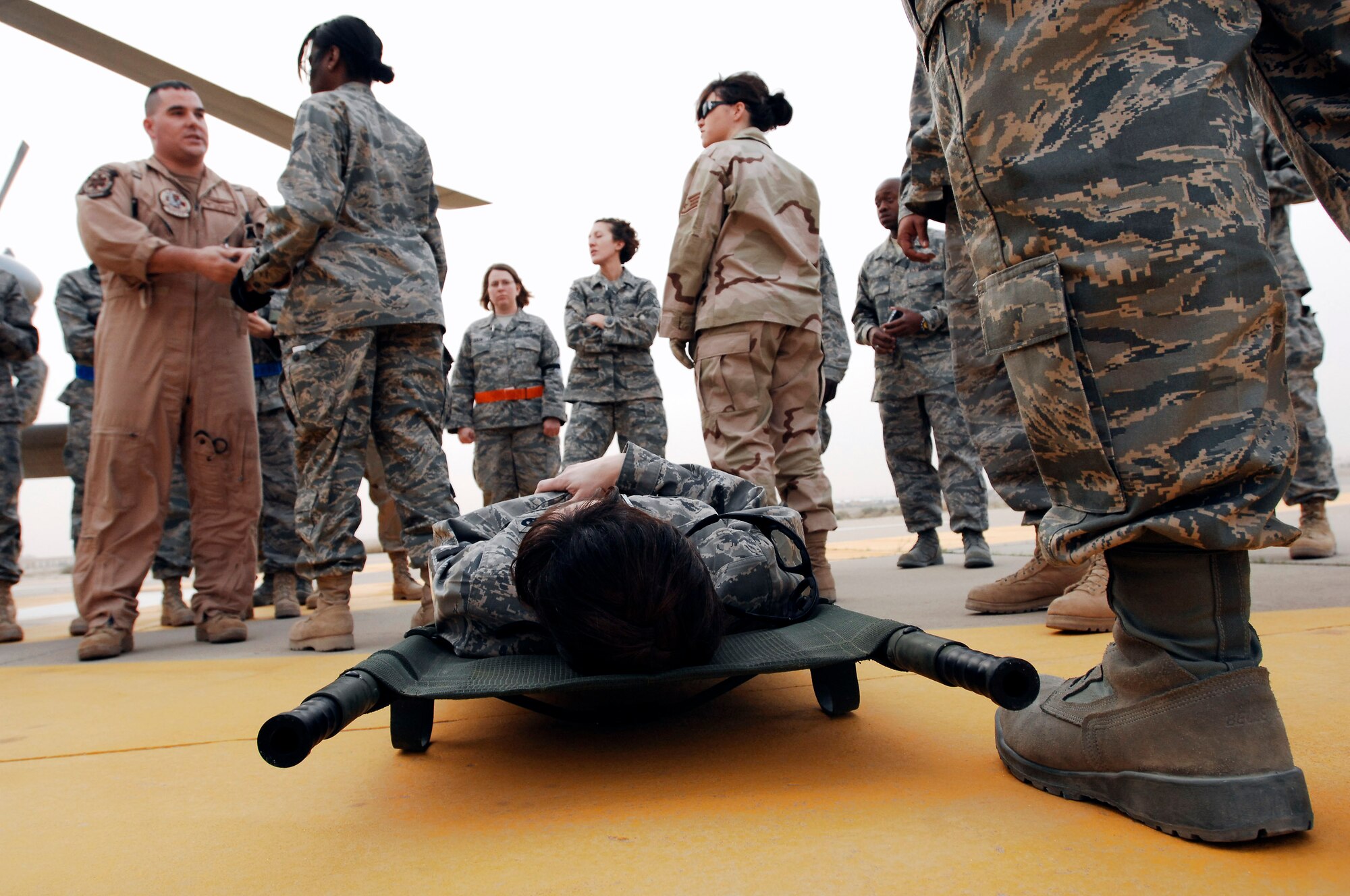 Navy Petty Officer 2nd Class Clayton Deese instructs Airmen from the 386th Expeditionary Medical Group while Capt. Loree Lunsford waits on a litter to be transported during litter management system training on a Navy MH-60 Sierra Feb. 18 at a Southwest Asia air base. The training familiarized medics on the loading and extracting techniques of patients for medical evacuation missions in support of operations Enduring Freedom and Iraqi Freedom. Captain Lunsford is a nurse from the 386th EMDG. (U.S. Air Force photo/Staff Sgt. Patrick Dixon) 
