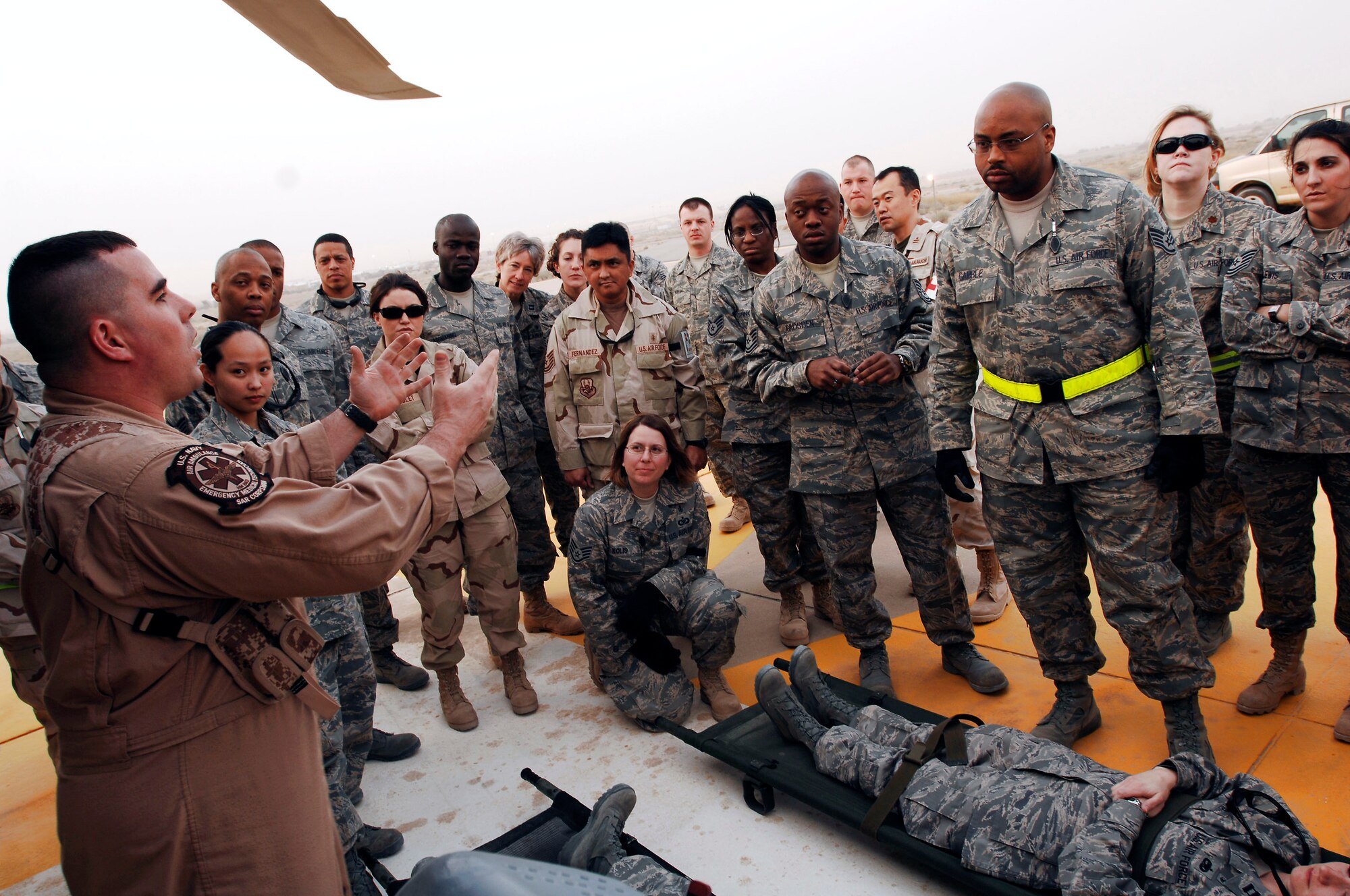 Airmen from the 386th Expeditionary Medical Group listen while Navy Petty Officer 2nd Class Clayton Deese speaks about the litter management system on a Navy MH-60 Sierra Feb. 18 at a Southwest Asia air base. The training familiarized medics on the loading and extracting techniques of patients for medical evacuation missions in support of operations Enduring Freedom and Iraqi Freedom. (U.S. Air Force photo/ Staff Sgt. Patrick Dixon) 
