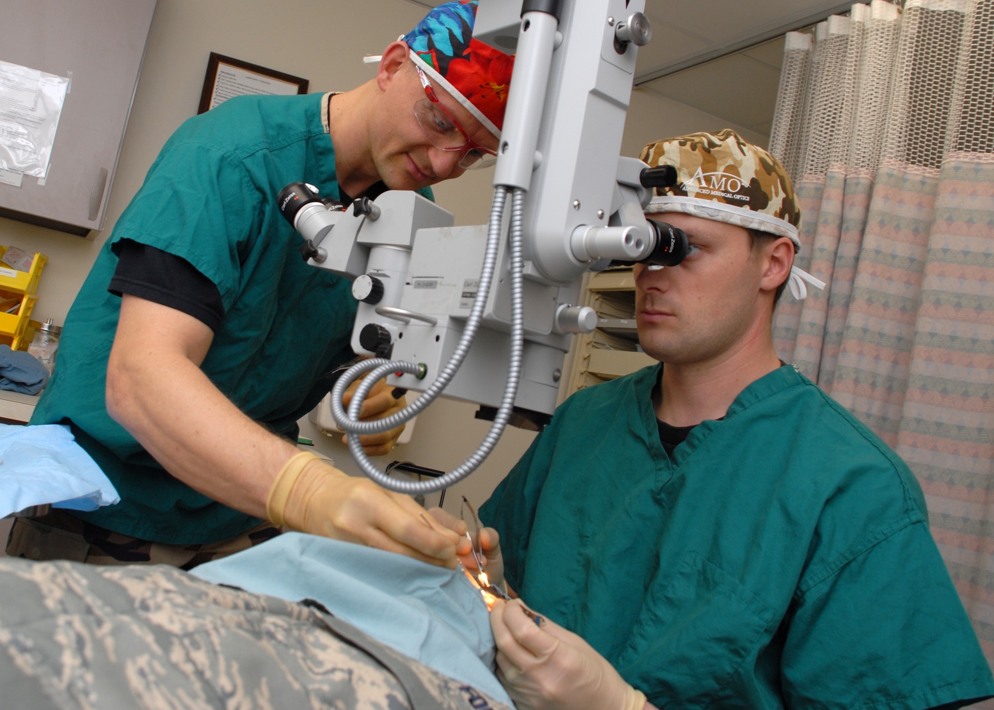 EGLIN AIR FORCE BASE, Fla. -- Senior Master Sgt. Erik D. Kessler, 96th Surgical Operations Squadron Surgical Specialty Flight Chief, assists Capt. Thomas Dahl, an ophthalmologist, during an examination of a patient in the Optometry Clinic. Sergeant Kessler was recently awarded the U.S. Air Force Col. Donald D. Dunton Award for his role in overseeing five clinics and 67 staff members. Sergeant Kessler is also the Top 3 president, an organization of senior enlisted Airmen at Eglin. Among his many accomplishments, Sergeant Kessler earned his third Community College of the Air Force Associate of Applied Science degree and is working toward a bachelor's degree in management. (U.S. Air Force photo by Staff Sgt. Mike Meares)