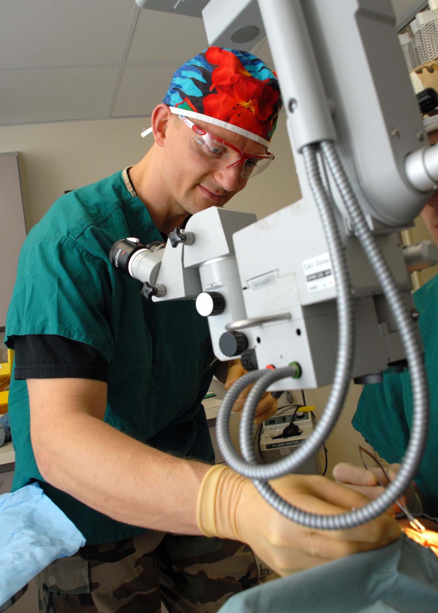 EGLIN AIR FORCE BASE, Fla. -- Senior Master Sgt. Erik D. Kessler, 96th Surgical Operations Squadron Surgical Specialty Flight Chief, assists an ophthalmologist during an examination of a patient in the Optometry Clinic. Sergeant Kessler was recently awarded the U.S. Air Force Col. Donald D. Dunton Award for his role in overseeing five clinics and 67 staff members. Sergeant Kessler is also the Top 3 president, an organization of senior enlisted Airmen at Eglin. Among his many accomplishments, Sergeant Kessler earned his third Community College of the Air Force Associate of Applied Science degree and is working toward a bachelor's degree in management. (U.S. Air Force photo by Staff Sgt. Mike Meares)