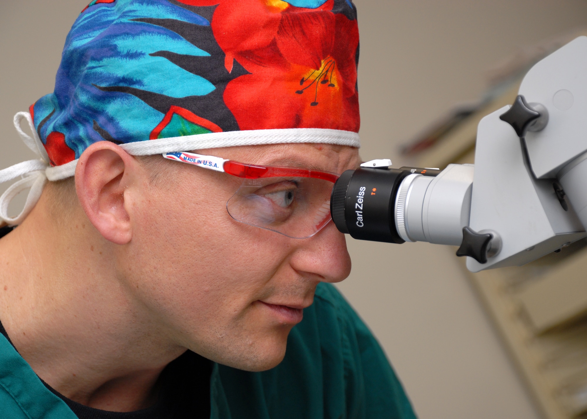 EGLIN AIR FORCE BASE, Fla. -- Senior Master Sgt. Erik D. Kessler, 96th Surgical Operations Squadron Surgical Specialty Flight Chief, assists an ophthalmologist during an examination of a patient in the Optometry Clinic. Sergeant Kessler was recently awarded the U.S. Air Force Col. Donald D. Dunton Award for his role in overseeing five clinics and 67 staff members. Sergeant Kessler is also the Top 3 president, an organization of senior enlisted Airmen at Eglin. Among his many accomplishments, Sergeant Kessler earned his third Community College of the Air Force Associate of Applied Science degree and is working toward a bachelor's degree in management. (U.S. Air Force photo by Staff Sgt. Mike Meares)