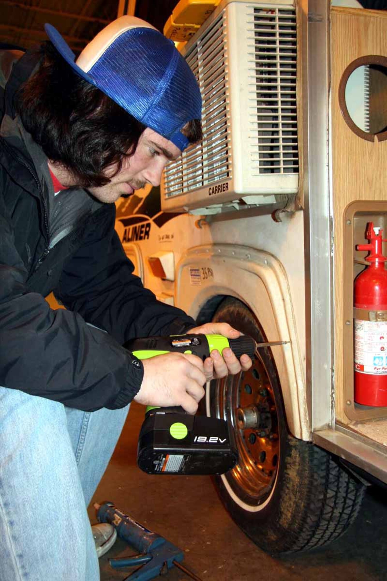 Blaine Bacon works on a pop up camper that can be rented from Equipment Checkout.  (Air Force photo by Becky Pillifant)

