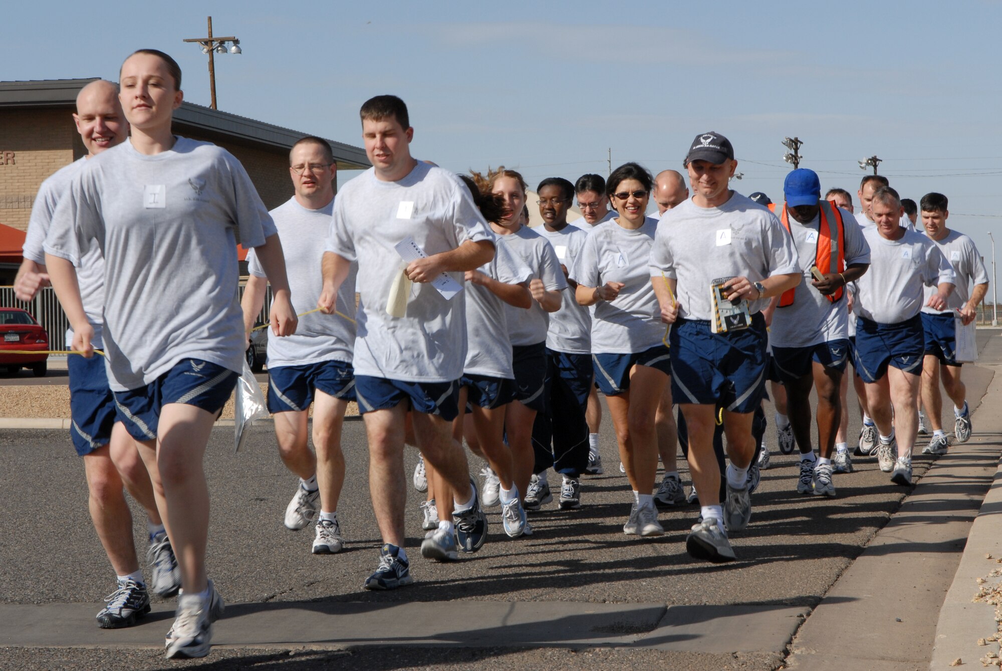 Members of the 56th Medical Group run together in teams to each obstacle during the medical challenge held at Fowler Park Feb. 14. The medical challenge requires teamwork to successfully complete the course. (photo by Staff Sgt. Jerry Fleshman)