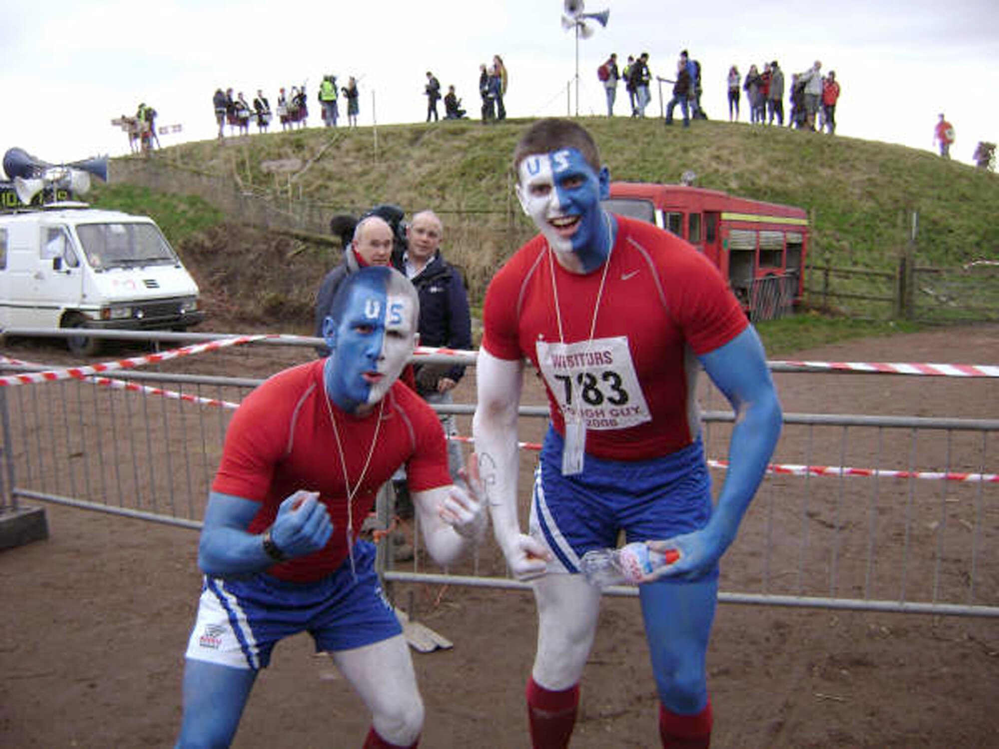 Second Lt. Jordan Kahn (right), 412th Flight Test Squadron casual lieutenant waiting for pilot training, and 2nd Lt. Thomas Smith, a maintenance officer at Ramstein Air Base, Germany, flex their muscles prior to the Tough Guy competition where they ran through a series of obstacles with fire, mud, water as well as barbed wires, electrically charged ropes and more mud on Jan. 27 in England. Lieutenant Kahn finished 762 out of 2,869 people competing in the annual Tough Guy competition. (Courtesy photo)