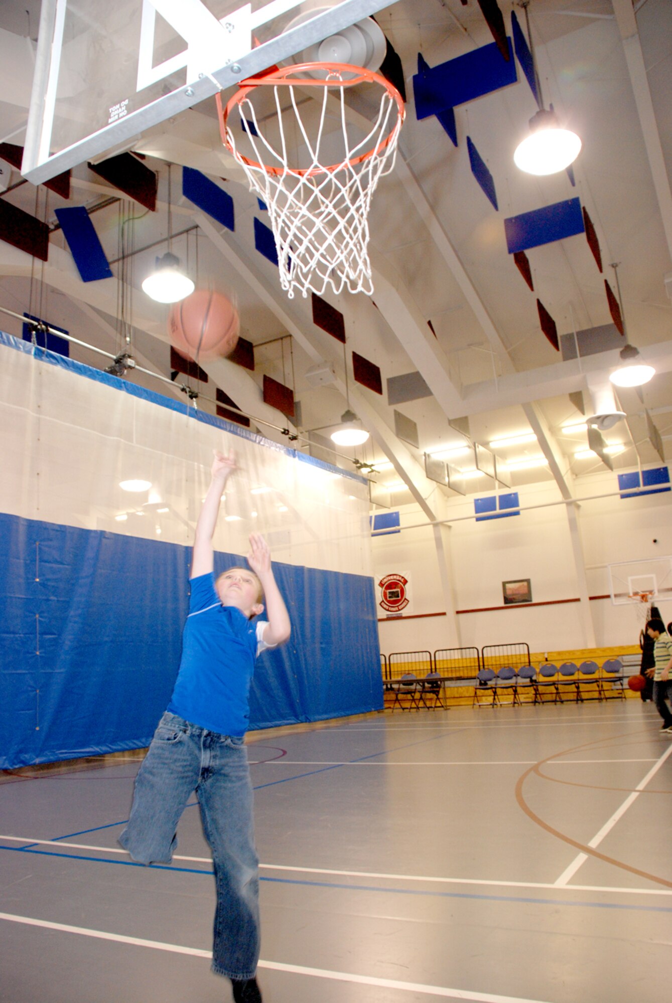 Shaun Black shoots a basketball toward the hoop in the Teen Center Feb. 7 (U.S. Air Force photo/Airman 1st Class Daryl Knee).

