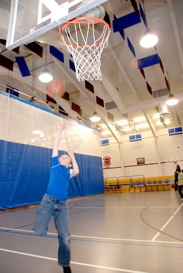 Shaun Black shoots a basketball toward the hoop in the Teen Center Feb. 7 (U.S. Air Force photo/Airman 1st Class Daryl Knee).
