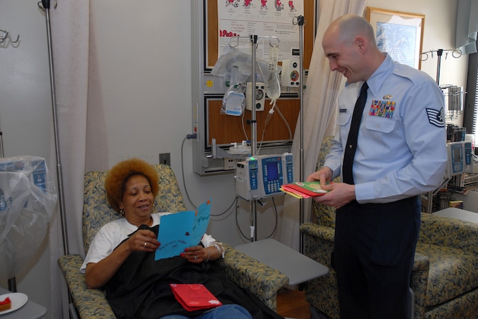 Tech. Sgt. Andrew Leighty gives Valentine's Day cards to Rachel Evans, a cancer patient, Feb. 14 at the Ralph H. Johnson VA Medical Center in Charleston. Sergeant Leighty is a 437th Maintenance Operations Squadron C-17A Maintenance Qualification Training Program instructor and First Six member who helped as part of the Valentines for Vets program. Children from Hunley Park Elementary School, Family Child Care and the Child Development Center made cards that were given to veterans. (U.S. Air Force photo/Airman 1st Class Melissa White)