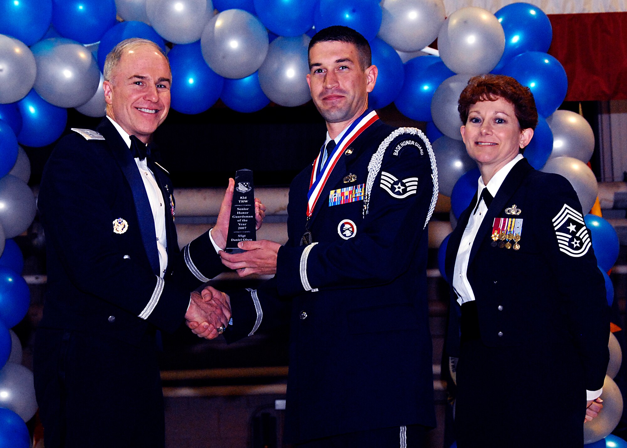 Brig. Gen. Richard Devereaux, 82nd Training Wing commander, presents Staff Sgt. Daniel Olsen, 82nd Training Group, with the Senior Honor Guardsman of the Year award Feb. 8 at the 82nd TRW Annual Awards Banquet. (U.S. Air Force photo/Harry Tonemah)