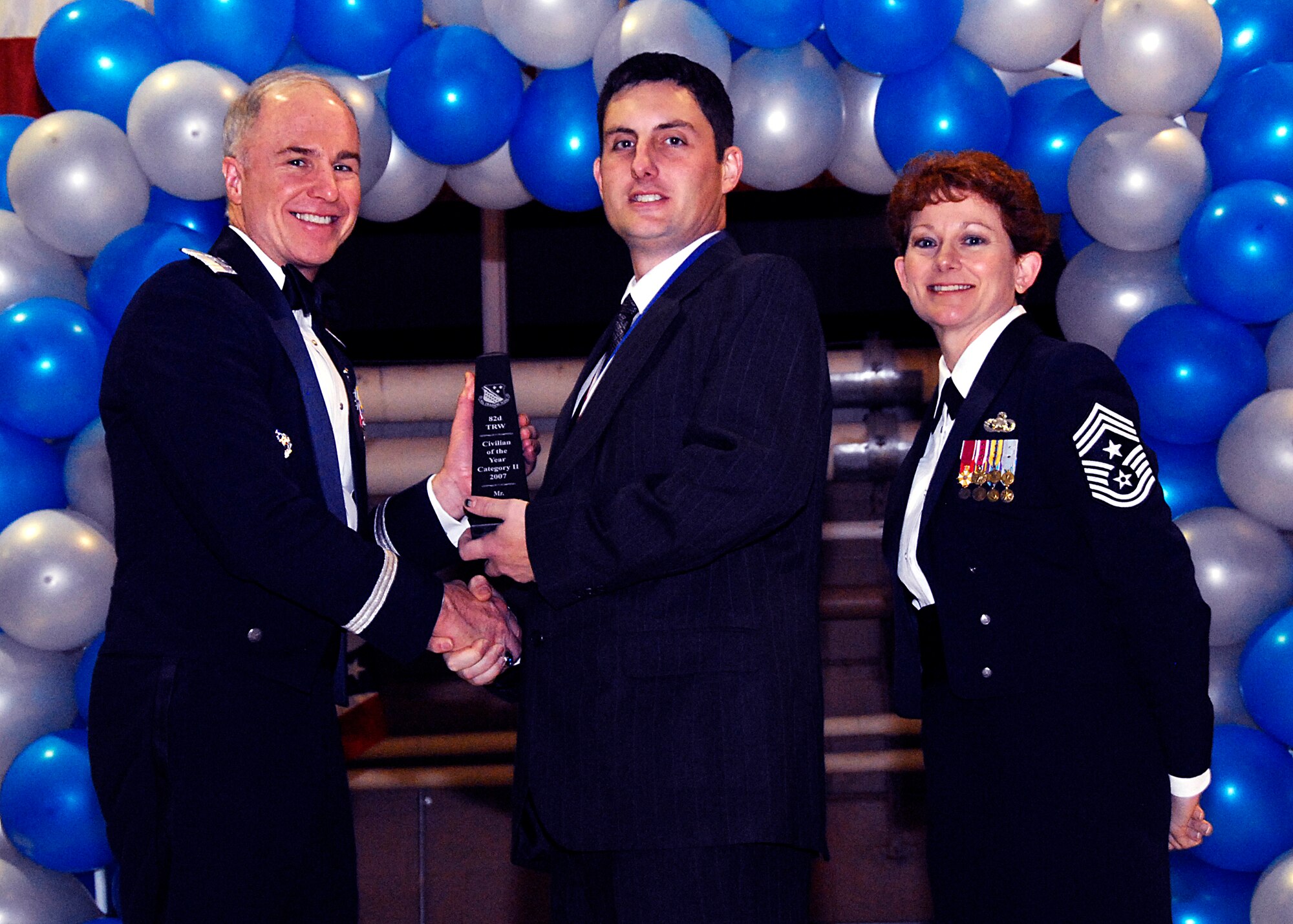 Brig. Gen. Richard Devereaux, 82nd Training Wing commander, presents Thomas Victory, 82nd Mission Support Group, with the Civilian of the Year award, category II, Feb. 8 at the 82nd TRW Annual Awards Banquet. (U.S. Air Force photo/Harry Tonemah)