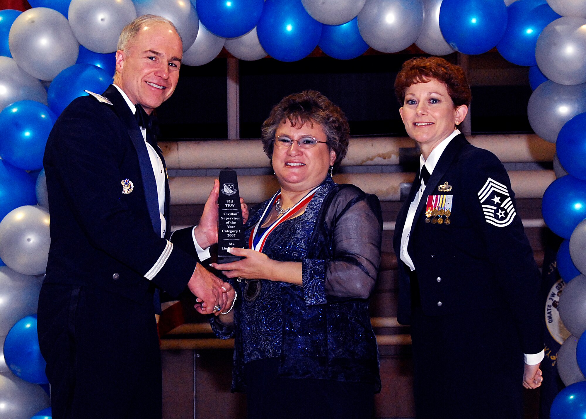Brig. Gen. Richard Devereaux, 82nd Training Wing commander, presents Linda Howard, 82nd Mission Support Group, with the Civilian of the Year, supervisory category I, award Feb. 8 at the 82nd TRW Annual Awards Banquet. (U.S. Air Force photo/Harry Tonemah)