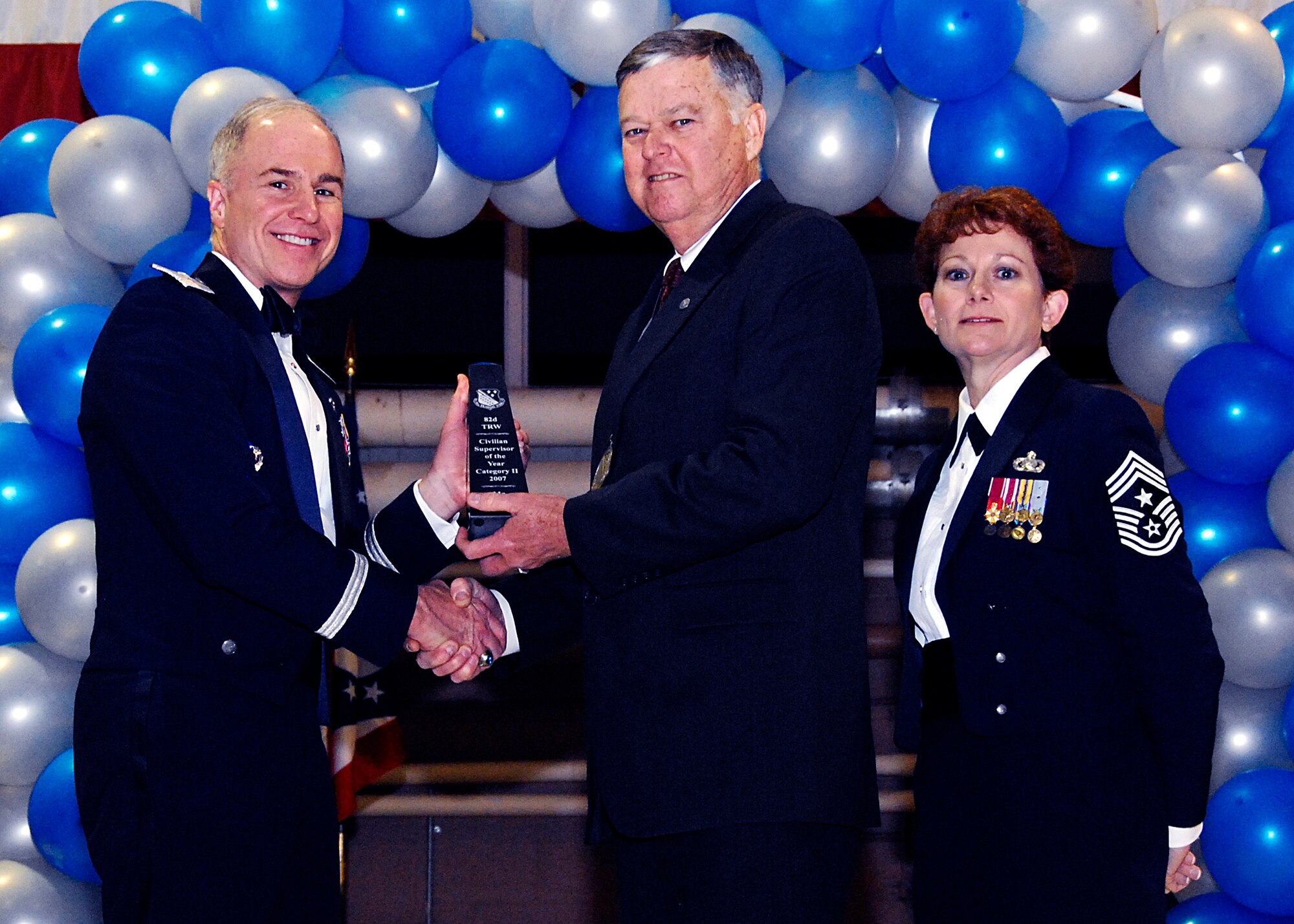 Brig. Gen. Richard Devereaux, 82nd Training Wing commander, presents Robert Dean, 782nd Training Group, with the Civilian of the Year, supervisory category II, award Feb. 8 at the 82nd TRW Annual Awards Banquet. (U.S. Air Force photo/Harry Tonemah)