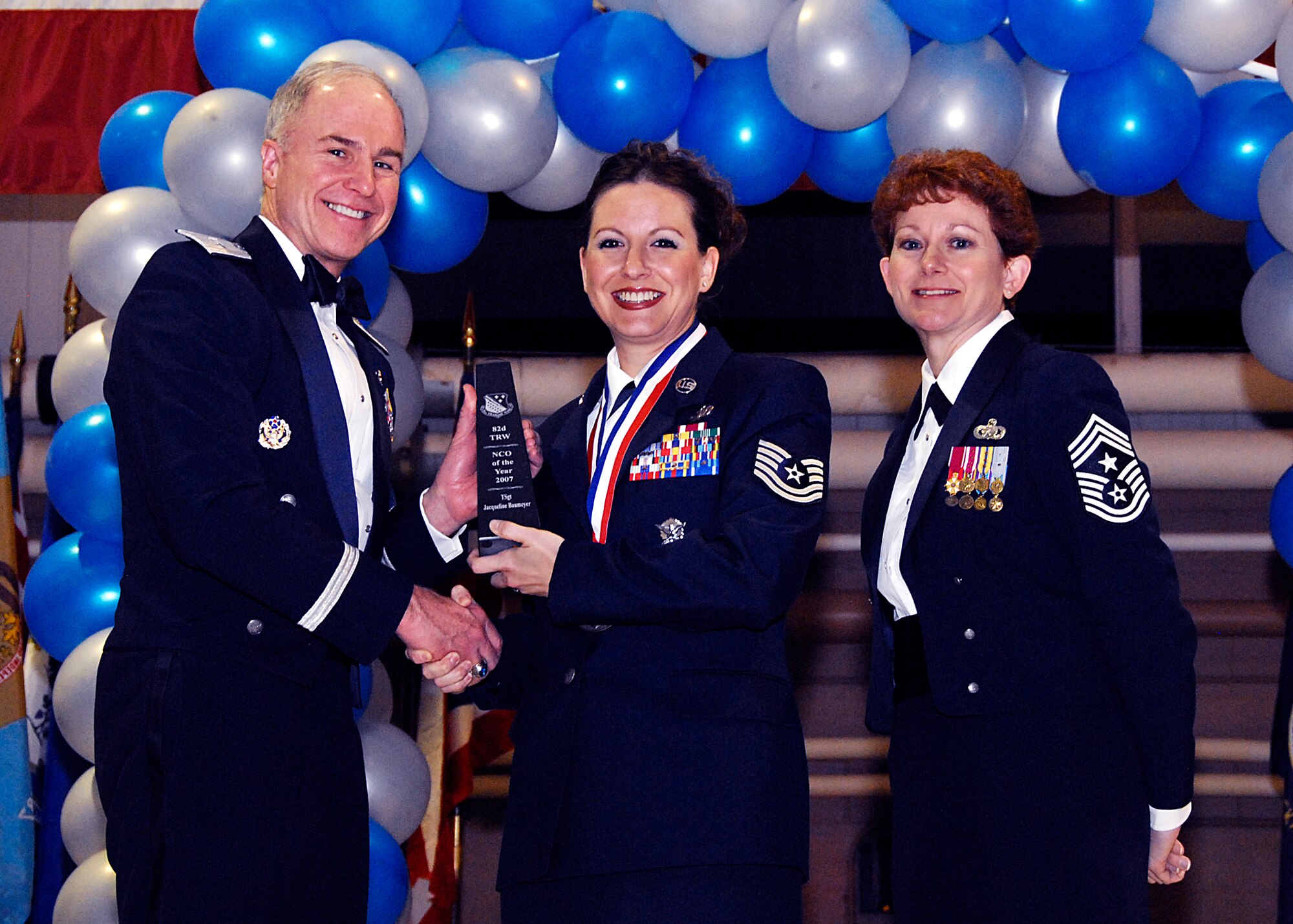 Brig. Gen. Richard Devereaux, 82nd Training Wing commander, presents Tech. Sgt. Jacqueline Baumeyer, 82nd Mission Support Group with the NCO of the Year award Feb. 8 at the 82nd TRW Annual Awards Banquet. (U.S. Air Force photo/Harry Tonemah)
