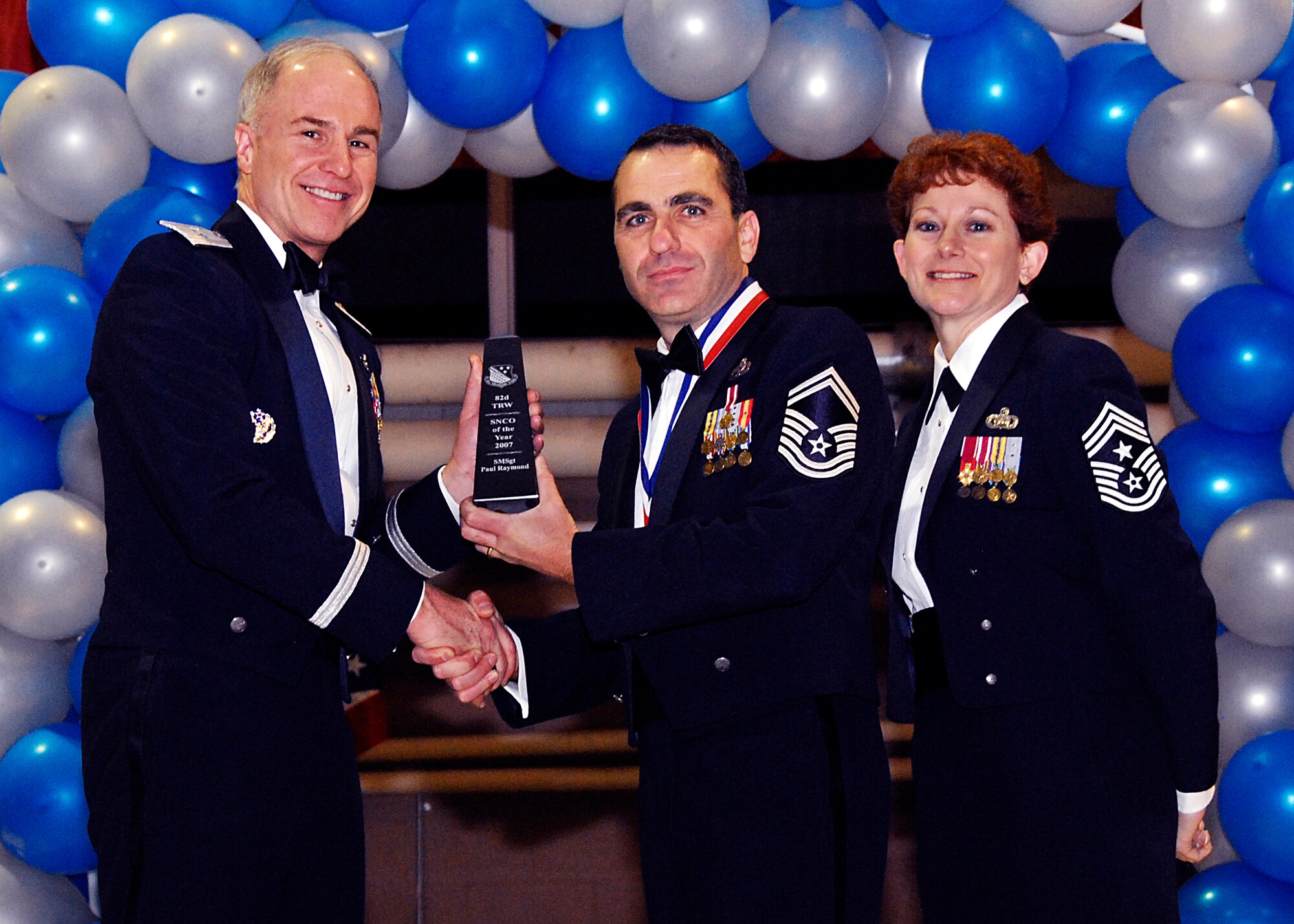 Brig. Gen. Richard Devereaux, 82nd Training Wing commander, presents Senior Master Sgt. Paul Raymond, 82nd Mission Support Group with the Senior NCO of the Year award Feb. 8 at the 82nd TRW Annual Awards Banquet. (U.S. Air Force photo/Harry Tonemah)