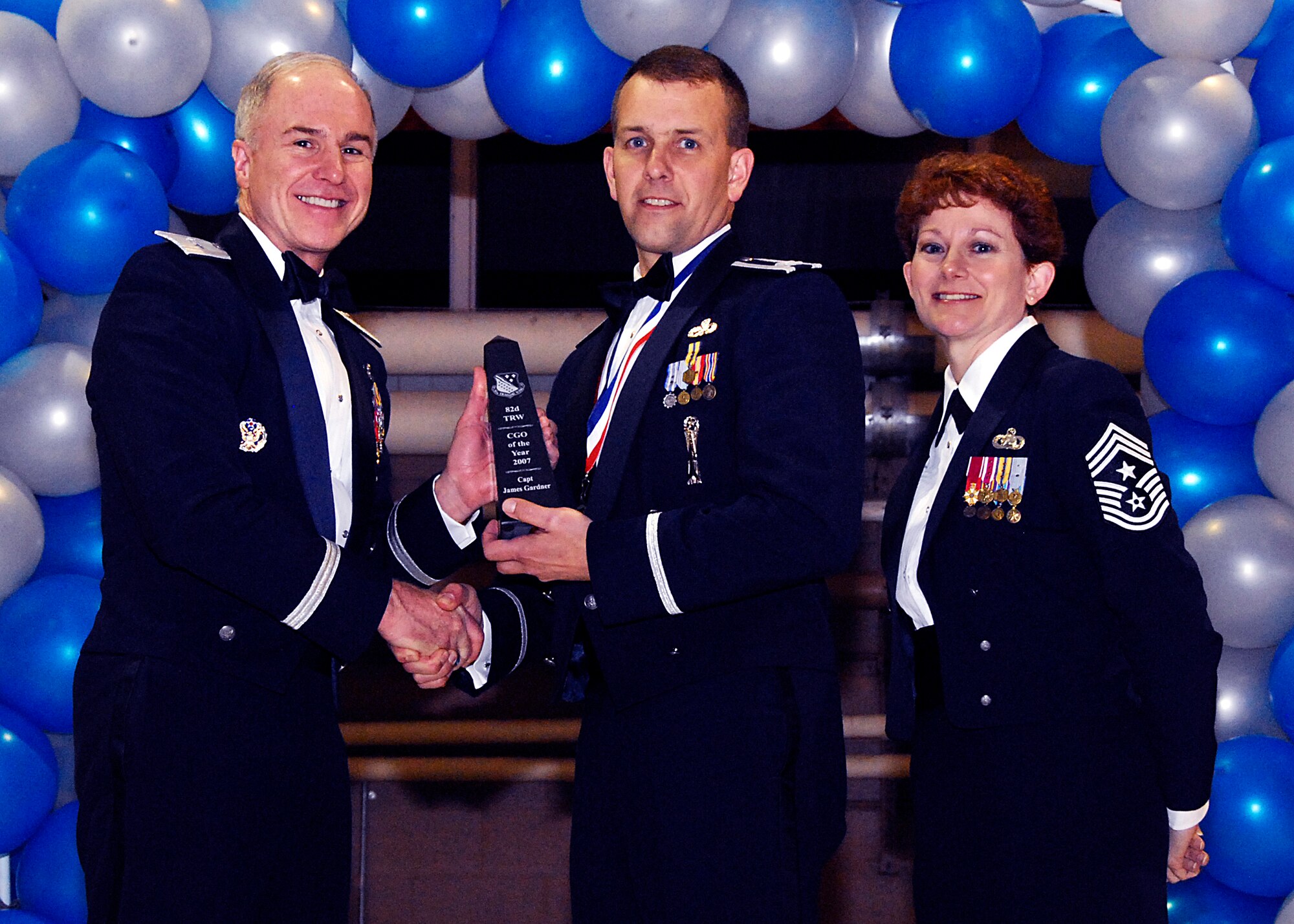Brig. Gen. Richard Devereaux, 82nd Training Wing commander, presents Captain James Gardner, 82nd Training Group, with the Company Grade Officer of the Year award Feb. 8 at the 82nd TRW Annual Awards Banquet. (U.S. Air Force photo/Harry Tonemah)