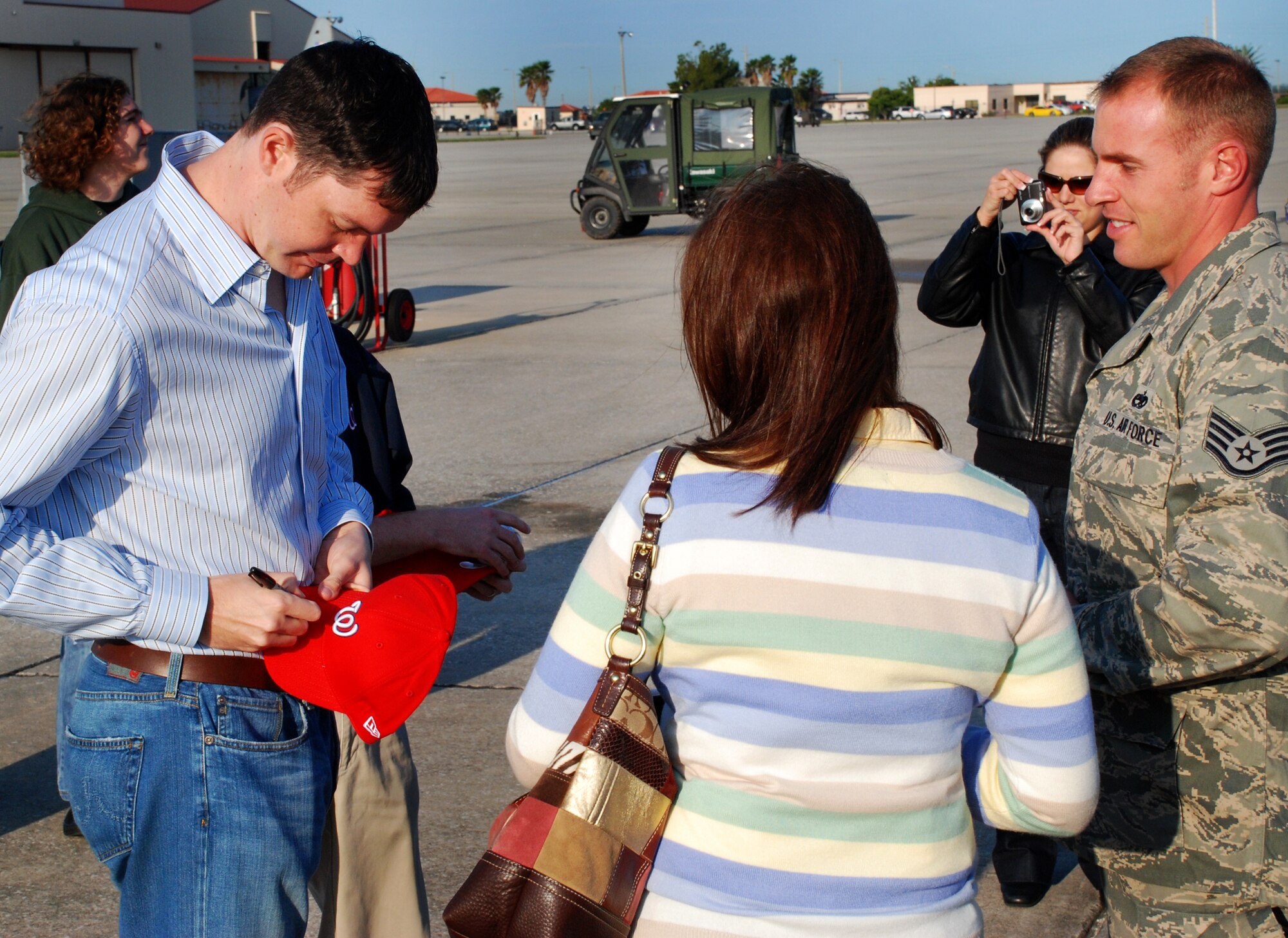 PATRICK AIR FORCE BASE, Fla. -- A small group of reservists from the 920th Rescue Wing here departed today on the first-leg of a 14-month deployment in support of Operation Enduring Freedom. Before they left, the deploying reservists were visited on the flightline by John Patterson, a pitcher for the Washington Nationals baseball team, which plays its spring-training games at nearby Space Coast Stadium. Mr. Patterson gave out hats and baseballs, signed autographs, visited with family members and personally thanked each Airman for their service. After saying their goodbyes, the reservists boarded one of the unit’s HC-130 Hercules aircraft en route to Arizona, where they will join helicopter pilots, aircrew and support personnel from the wing’s subordinate unit at Davis-Monthan AFB. The group of approximately 80 wing personnel will then head for Afghanistan for the first half of a mobilization to support the U.S. Army medical evacuation operation. Later this year, the 920th will send another group of reservists from here to pick up the second half of the mission. The wing’s primary wartime job is combat search and rescue, which involves locating and rescuing servicemembers isolated in combat—such as pilots shot down behind enemy lines. The medevac deployment, called an “in-lieu-of” mission, marks the first time the 920th will undertake the role for the Army. (U.S. Air Force photo/Staff Sgt. Paul Flipse)