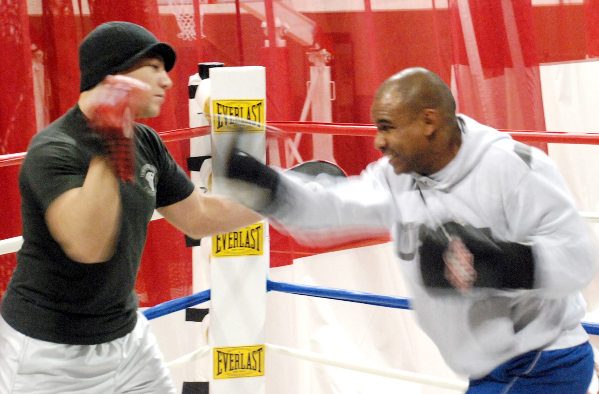 Capt. David Suszko, 319th Missile Squadron, works the mitts with Capt. Rodney Ellison, 319th MS, Jan. 29 at the Fall Hall Community Center. Captain Ellison has been the Air Force light heavyweight boxing champion and second in the Defense Department for the past three years (U.S. Air Force photo/Staff Sgt. Chad Thompson).