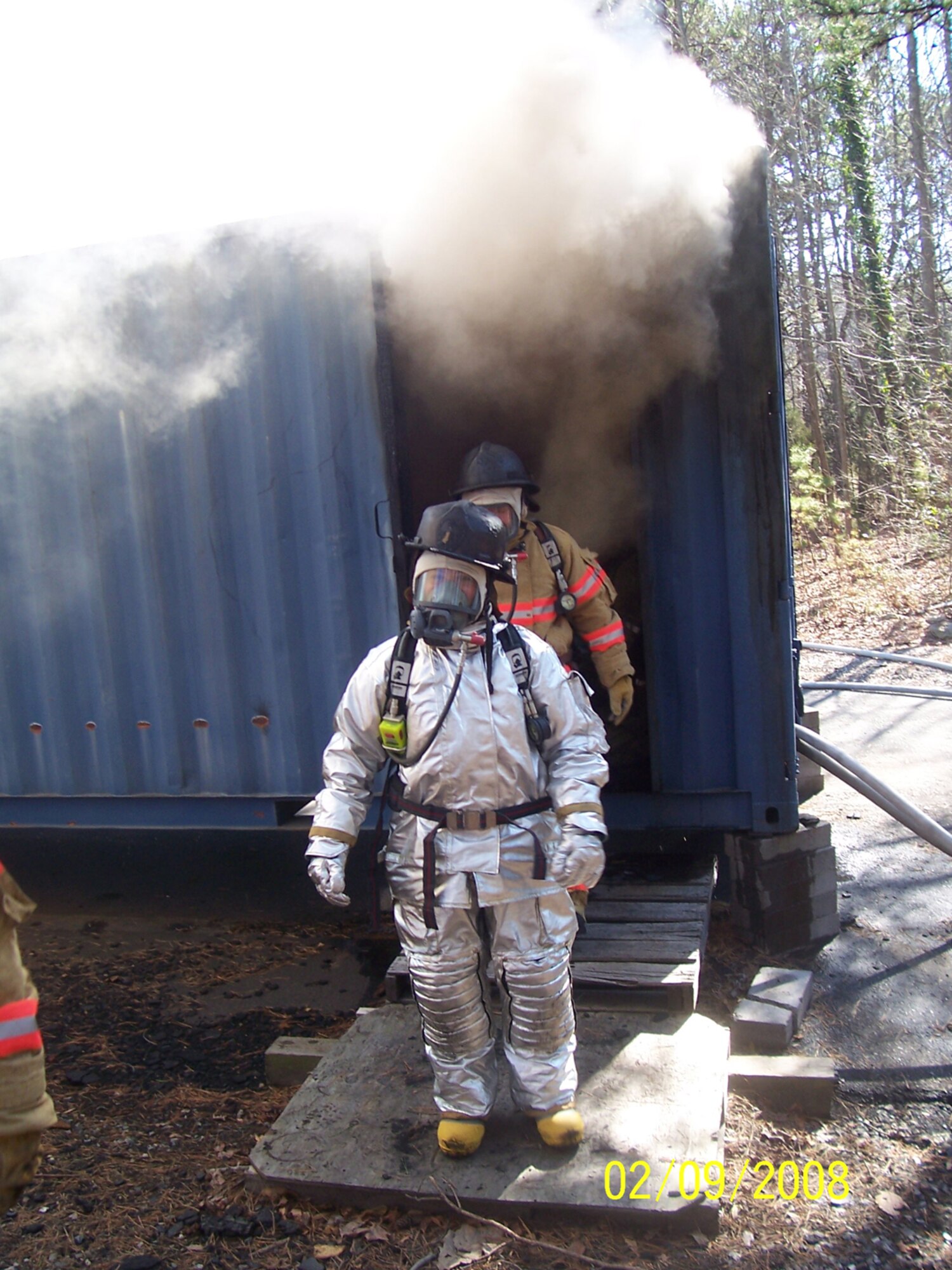 SEYMOUR JOHNSON AIR FORCE BASE, N.C. -- Lt. Col. Kerri Grimes, commander of the 916th Civil Engineer Squadron, emerges from the flashover simulator training building during a recent exercise. The building, located at the Gaston Community College Regional Training Center in Charlotte, N.C., helps firefighters train for real world emergencies. More than 50 reservists attended a four-day exercise in the Charlotte area in mid-February.