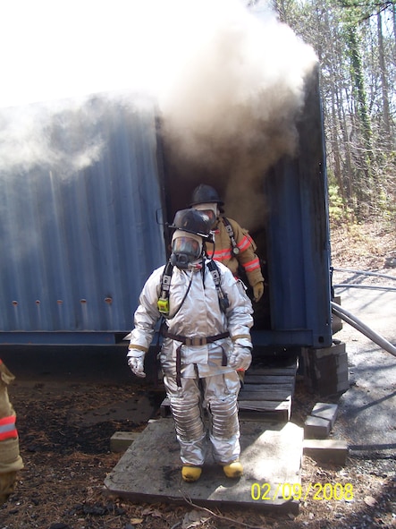 SEYMOUR JOHNSON AIR FORCE BASE, N.C. -- Lt. Col. Kerri Grimes, commander of the 916th Civil Engineer Squadron, emerges from the flashover simulator training building during a recent exercise. The building, located at the Gaston Community College Regional Training Center in Charlotte, N.C., helps firefighters train for real world emergencies. More than 50 reservists attended a four-day exercise in the Charlotte area in mid-February.