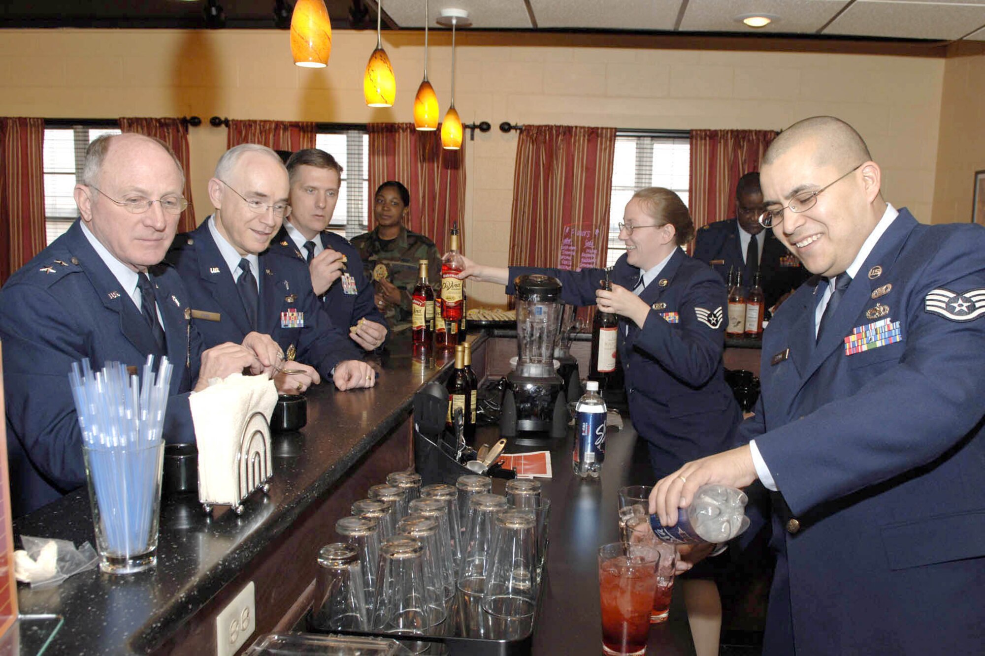 DYESS AFB, Texas -- Staff Sergeant Jahn Espino pours a gourmet blend of coffee at the Soul Fire Cafe's grand opening, Feb. 15. The cafe was built by volunteers for a place Airman could visit with friends and drink free coffee. (U.S. Air Force photo by Staff Sergeant Connor Estes)