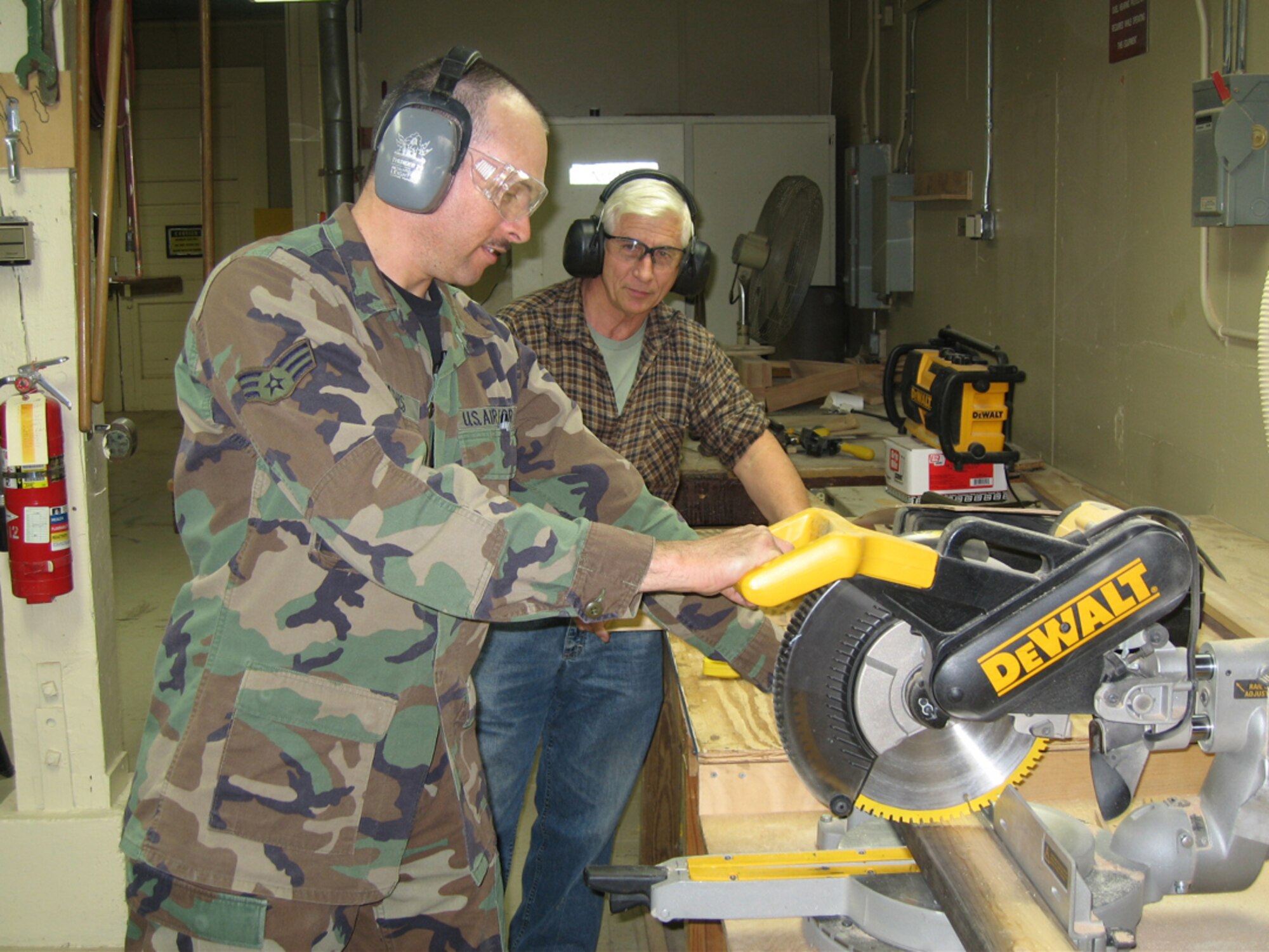 SEYMOUR JOHNSON AIR FORCE BASE, N.C. -- Seninor Airman Gary Mathis (front) cuts wood with Senior Master Sgt. (ret.) Ben King.  Airman Mathis is a structure journeyman with the 916th Civil Engineer Squadron. He is a currently in enrolled in a seasoning program, which helps him hone his Reserve skills while working with the active duty 4th Fighter Wing Civil Engineer Squadron.  Mr. King is a structures shop supervisor and retired as a member of the Air Force Reserve squadron.