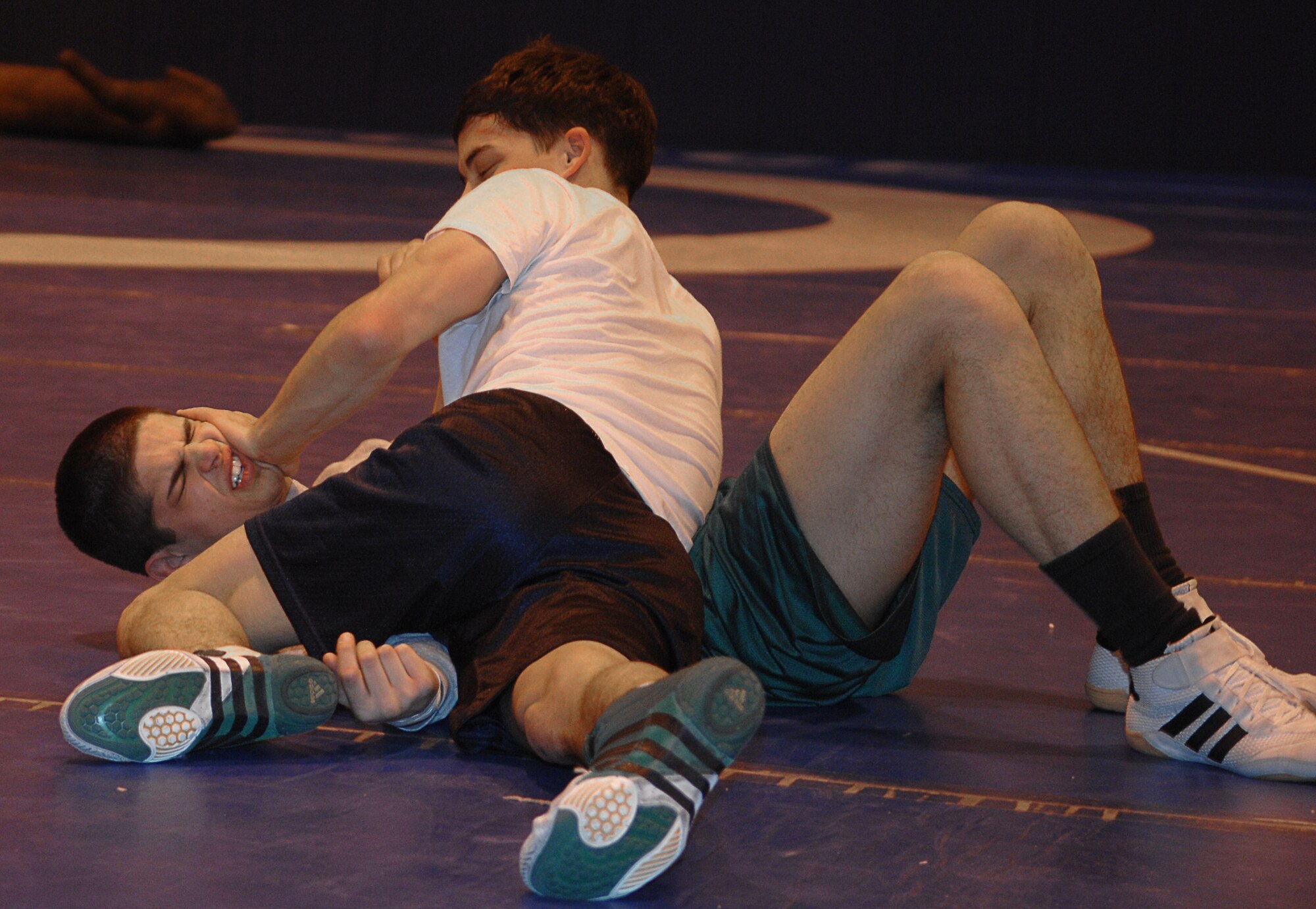 MOUNTAIN HOME AIR FORCE BASE, Idaho -- Bottom, Dean Maraj, RAF Croughton, United Kingdom, and Jason DeRosa, Kadena Air Base, Japan, practice their wrestling moves during the All Air Force Wrestling Camp hosted by the 366th Services Squadron at the fitness center here Feb. 19. Beginning Feb. 13, almost two dozen potential candidates for the All Air Force Wrestling Team began tryouts for the 2008 wrestling season. After more than 120 candidates sent applications to Richard Estrella, the Air Force wrestling coach for 21 years, he chose the most promising to compete for the 14 available slots on the team. (U.S. Air Force photo/Airman 1st Class Stephany Miller)
