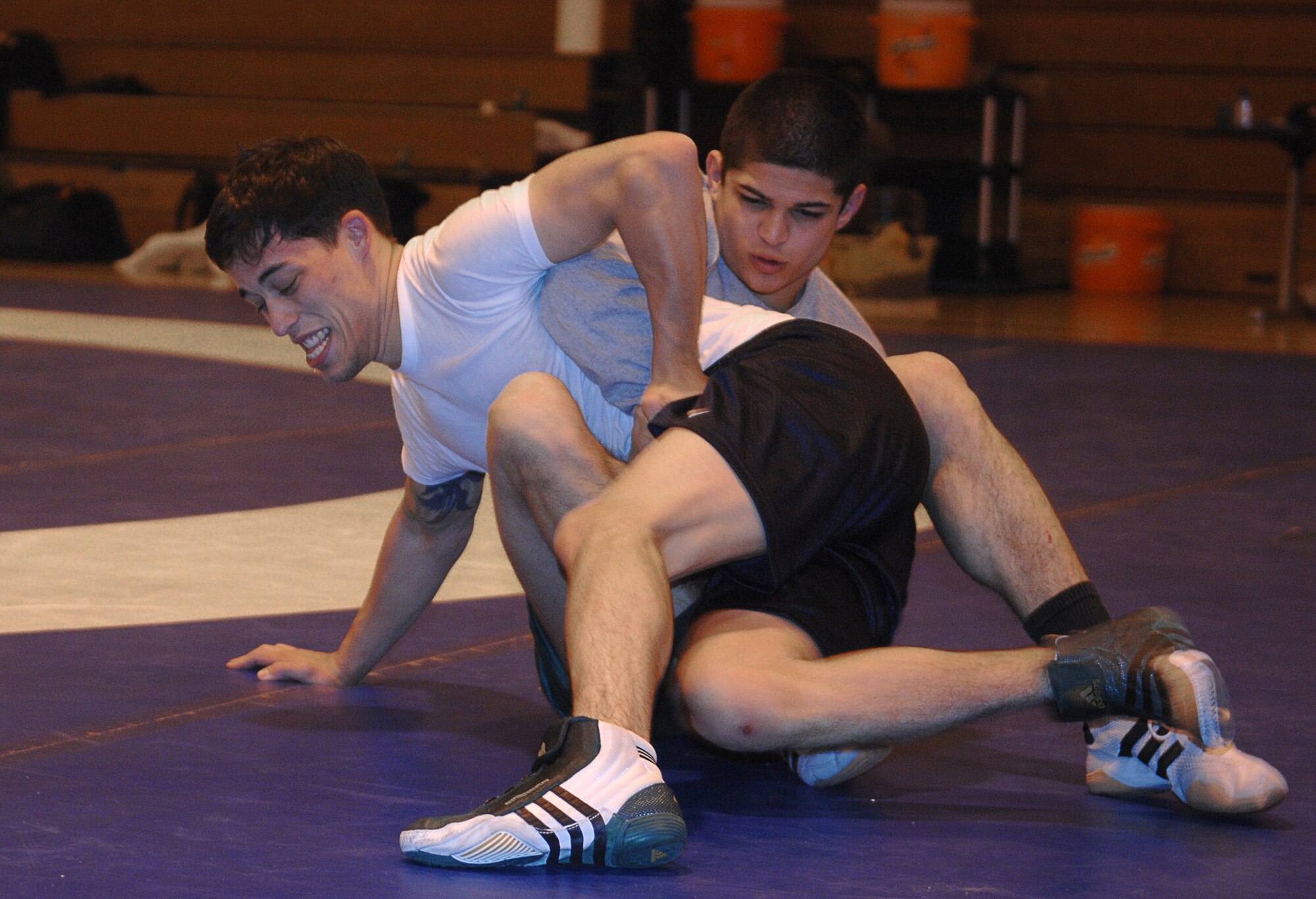 MOUNTAIN HOME AIR FORCE BASE, Idaho -- Left, Jason DeRosa, Kadena Air Base, Japan, and Dean Maraj, RAF Croughton, United Kingdom, practice their wrestling moves during the All Air Force Wrestling Camp hosted by the 366th Services Squadron at the fitness center here Feb. 19. Beginning Feb. 13, almost two dozen potential candidates for the All Air Force Wrestling Team began tryouts for the 2008 wrestling season. After more than 120 candidates sent applications to Richard Estrella, the Air Force wrestling coach for 21 years, he chose the most promising to compete for the 14 available slots on the team. (U.S. Air Force photo/Airman 1st Class Stephany Miller)