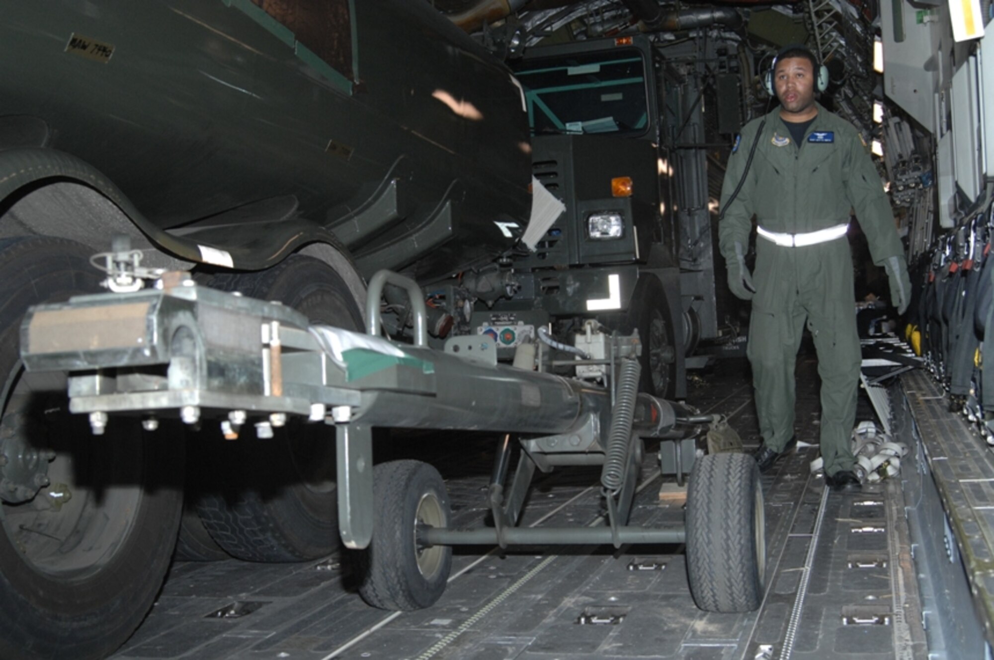 DAR ES SALAAM, Tanzania -- Loadmaster Staff Sgt. Jeff Smith surveys the fuel trucks and a tow bar for offloading from a C-17 after arriving here Feb. 15. 
More than 20 C-17s missions brought in the necessary equipment and personnel to support the president's visit to Tanzania.  Sergeant Smith says he loves the traveling aspect of his job and is proud to support the president's mission to Africa.