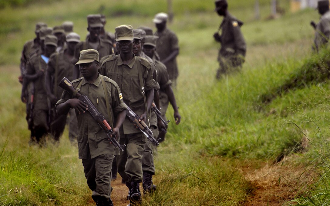 Ugandan army soldiers walk single file back from their barracks after a lunch break to begin another session of a land navigation, Feb. 12, 2008.