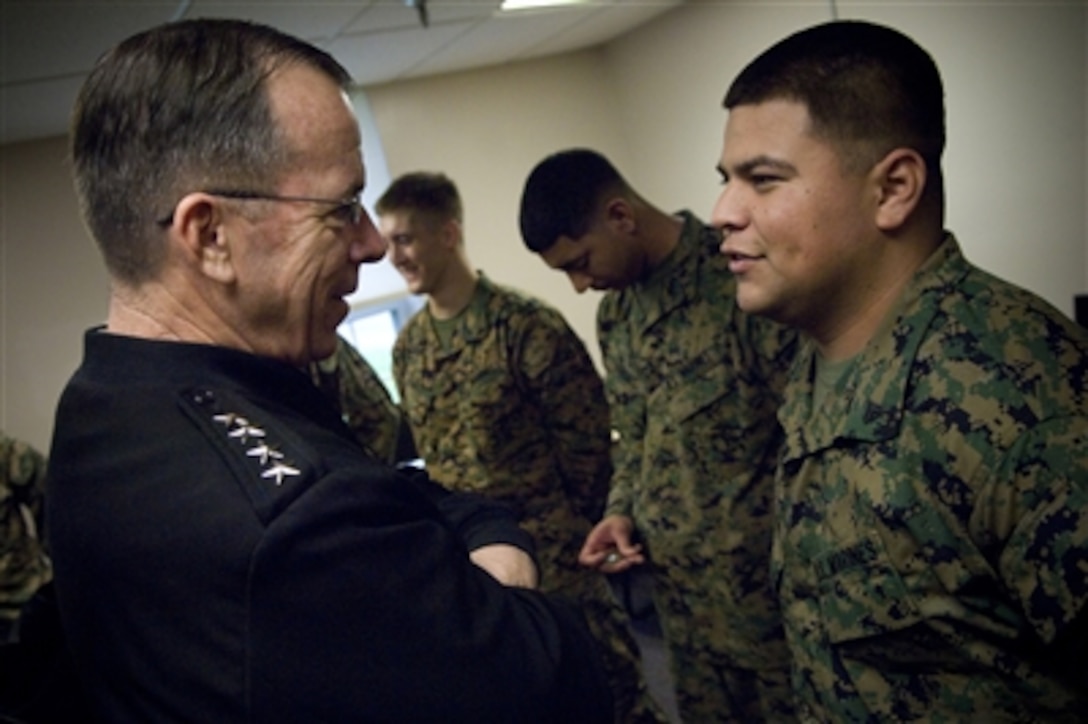 Chairman of the Joint Chiefs of Staff Adm. Mike Mullen, U.S. Navy, speaks with U.S. Marine Corps Cpl. Giovanni Morales, a resident of the Wounded Warrior Battalion West, during a meeting at Camp Pendleton, Calif., on Feb. 17, 2008.  Mullen and his wife Deborah visited the base to speak with Marines and to witness the unveiling of the new infantry immersion trainer. The close quarters battle simulator provides realistic training by using live actors, pyrotechnics, sight, sound and smell to teach battlefield tactics.  
