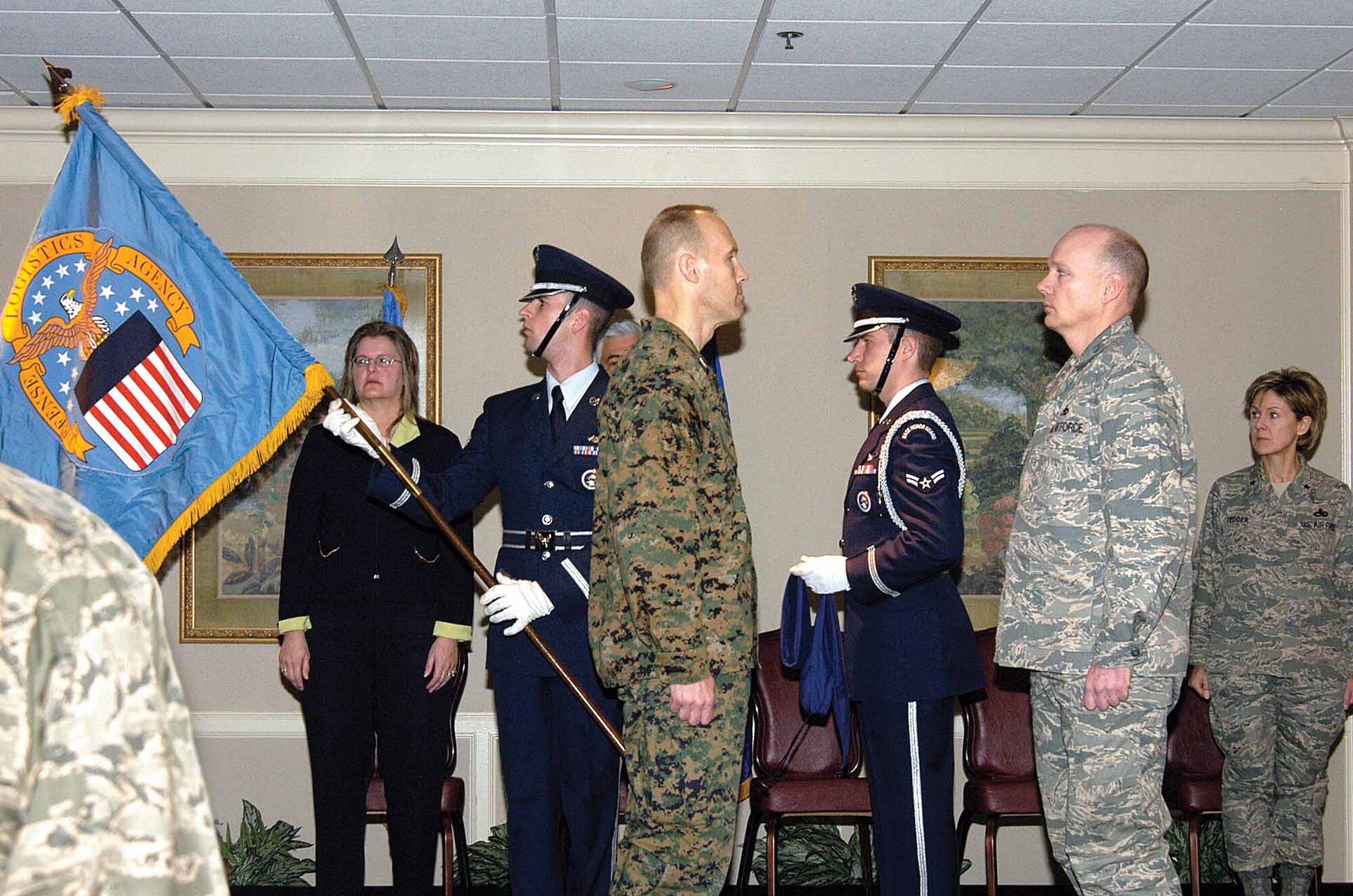 The Defense Logistics Agency guidon is unfurled by Tinker Honor Guard members at the Tinker Club Feb. 8 during a ceremony activating DLA Oklahoma City and deactivating the 776th Maintenance Support Squadron.  Col. Gary Wiest, left, conferred command of DLA Oklahoma City to Lt. Col. Kelly Larson.  Watching the event are Tinker’s Elaine Dockray, 776th MSS director, and Brig. Gen. Judith Fedder, 76th Maintenance Wing commander. (Air Force photo by Margo Wright)