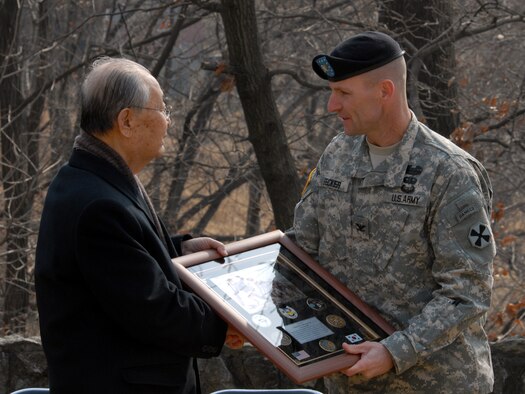 Col. Bradley Becker, (right), 3rd Battlefield Coordination commander, presents a gift of appreciation to (retired) Republic of Korea Army Gen. Paik, Sun Yup. General Paik was the guest speaker during the Hill 180 remembrance ceremony Feb. 21. (U.S. Air Force photo/Staff Sgt. Lakisha Croley) 
