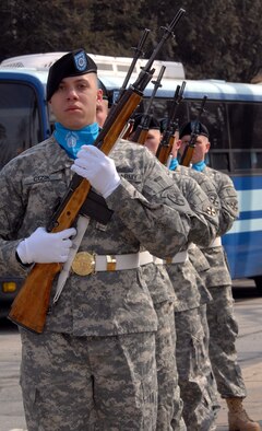 Members of the Osan Honor Guard, prepare to post the colors during the Hill 180 ceremony Feb. 21. The ceremony paid tribute to the gallant actions of the soldiers from the 27th Infantry Regiment "Wolfhounds” during a bayonet charge up Hill 180. (U.S. Air Force photo/Staff Sgt. Lakisha Croley) 
