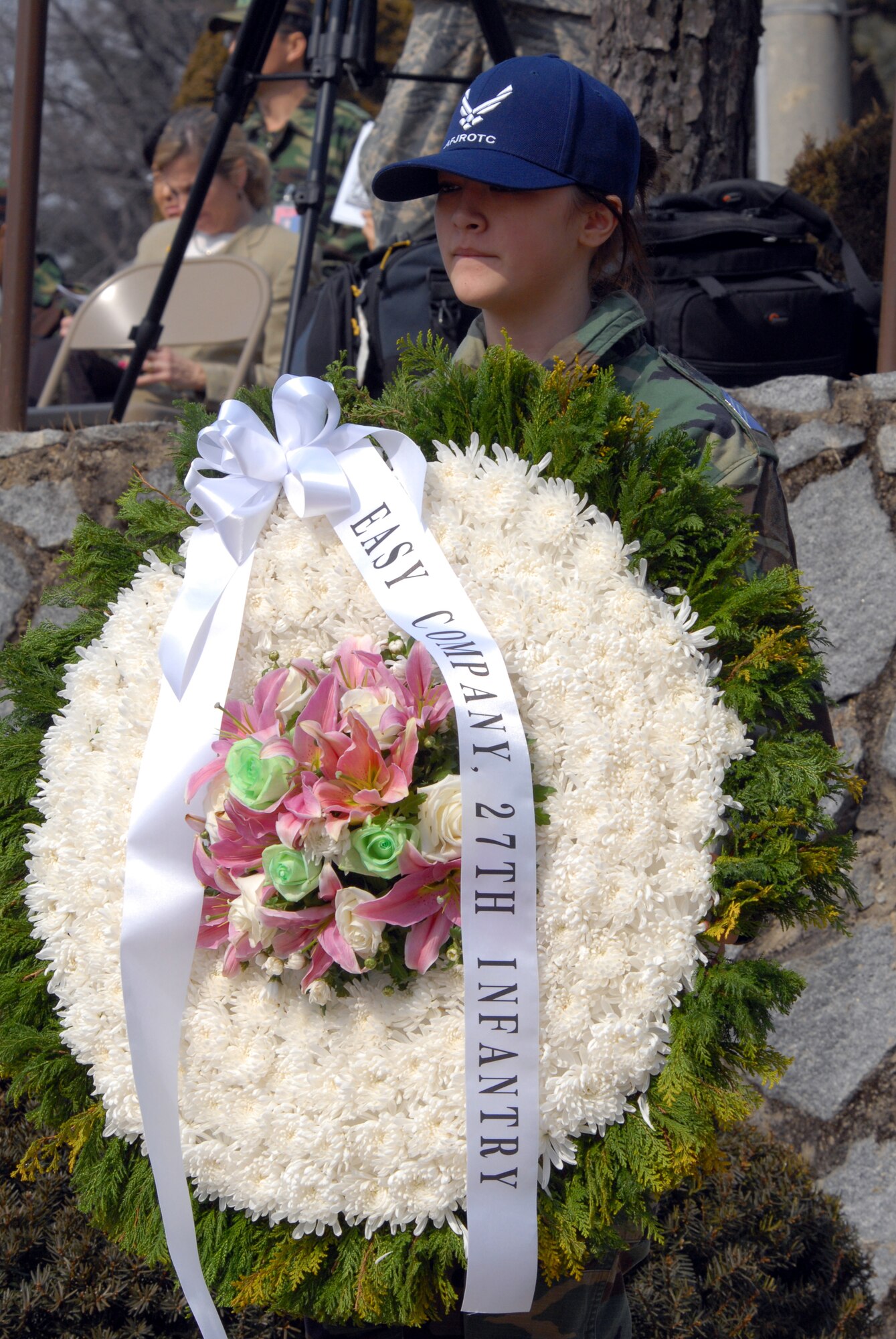 OSAN AIR BASE, Republic of Korea – A member of the Air Force Junior ROTC stands next to a memorial wreath during the Hill 180 remembrance ceremony Feb. 21. The ceremony also included a rifle salute by the United Nations Command Honor Guard, an  A-10/F-16 flyover and the playing of “Taps.” (U.S. Air Force photo/Staff Sgt. Lakisha Croley)