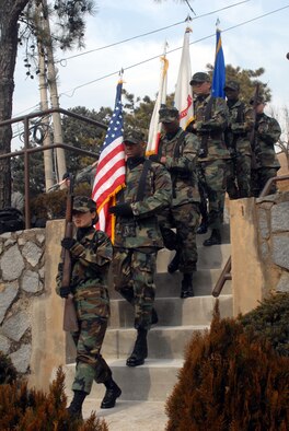 Members of the Osan Honor Guard, prepare to post the colors during the Hill 180 ceremony Feb. 21. The ceremony paid tribute to the gallant actions of the soldiers from the 27th Infantry Regiment "Wolfhounds” during a bayonet charge up Hill 180. (U.S. Air Force photo/Staff Sgt. Lakisha Croley) 
