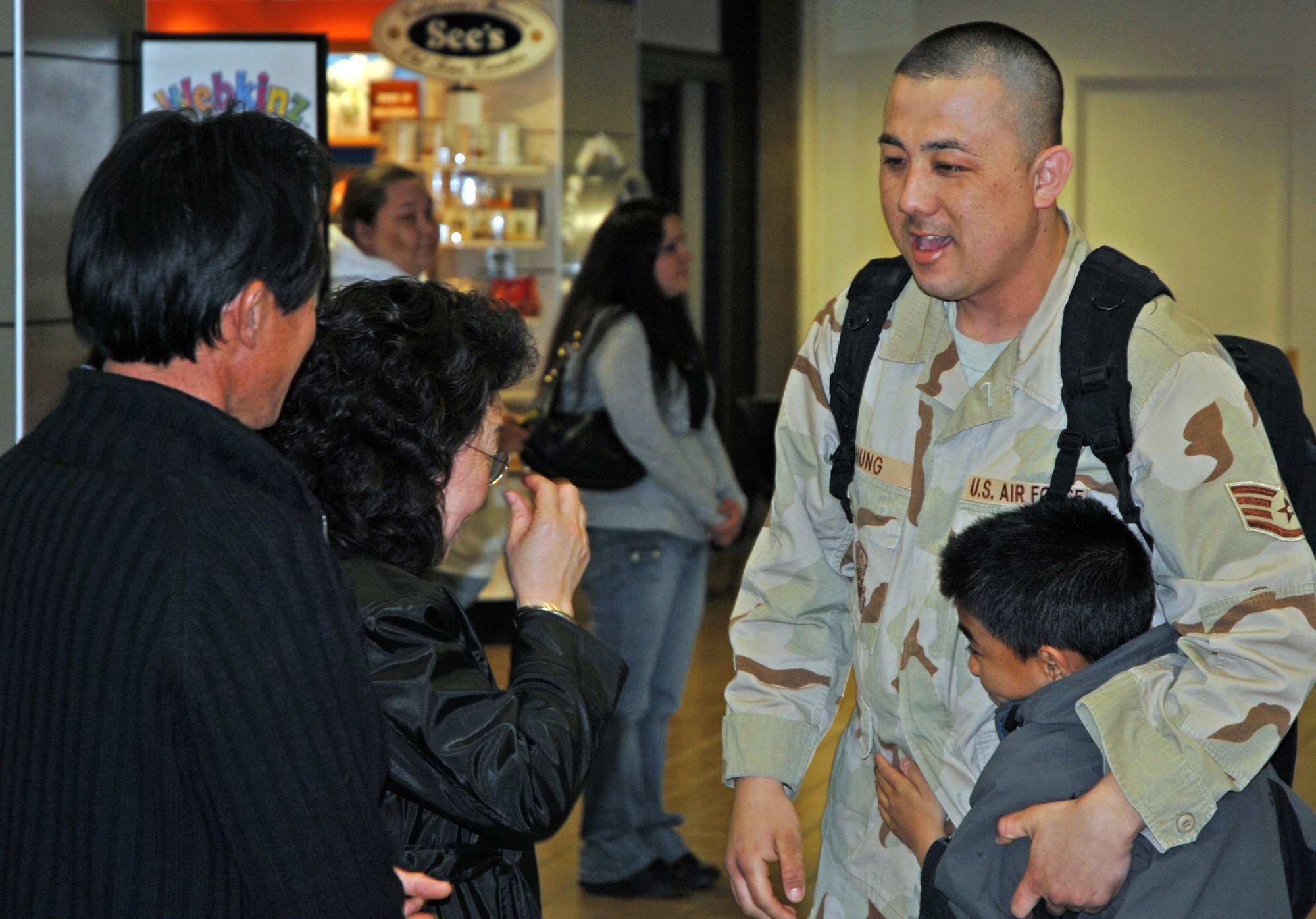 Air Force Reservist Staff Sergeant Timothy A. Chung is surrounded by his happy family at Sacramento International Airport after returning Feb. 18, 2008 from a six month mobilization. Sergeant Chung, a vehicle operator assigned to the 940th Logistics Readiness Squadron, Beale Air Force Base, Calif., was assigned to the 376th Air Expeditionary Wing, Manas Air Base, in the former Soviet republic of Kyrgyzstan in Central Asia. (U.S. Air Force photo/Master Sgt. Ellen L. Hatfield)