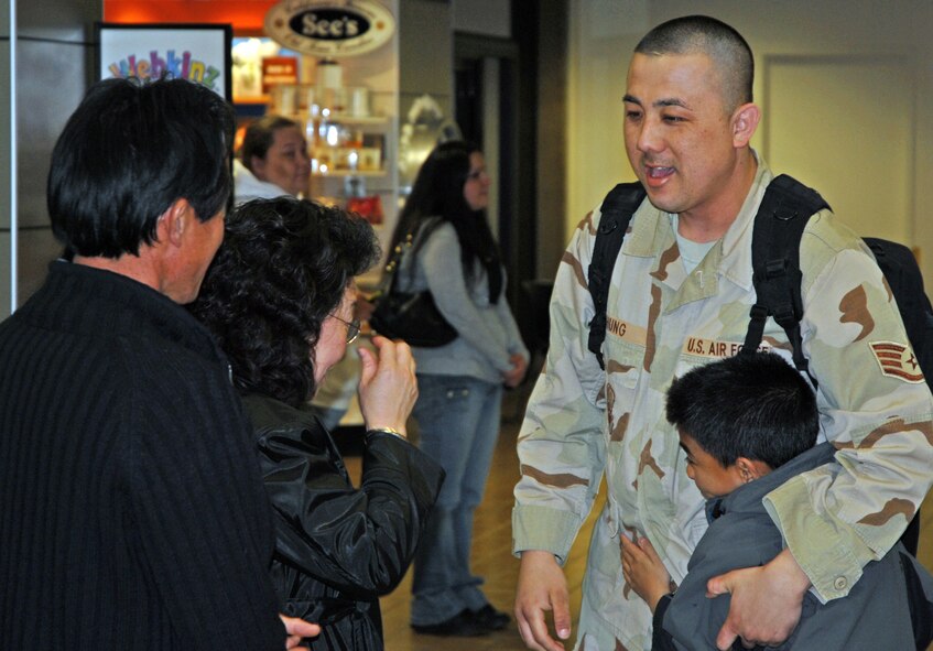 Air Force Reservist Staff Sergeant Timothy A. Chung is surrounded by his happy family at Sacramento International Airport after returning Feb. 18, 2008 from a six month mobilization. Sergeant Chung, a vehicle operator assigned to the 940th Logistics Readiness Squadron, Beale Air Force Base, Calif., was assigned to the 376th Air Expeditionary Wing, Manas Air Base, in the former Soviet republic of Kyrgyzstan in Central Asia. (U.S. Air Force photo/Master Sgt. Ellen L. Hatfield)