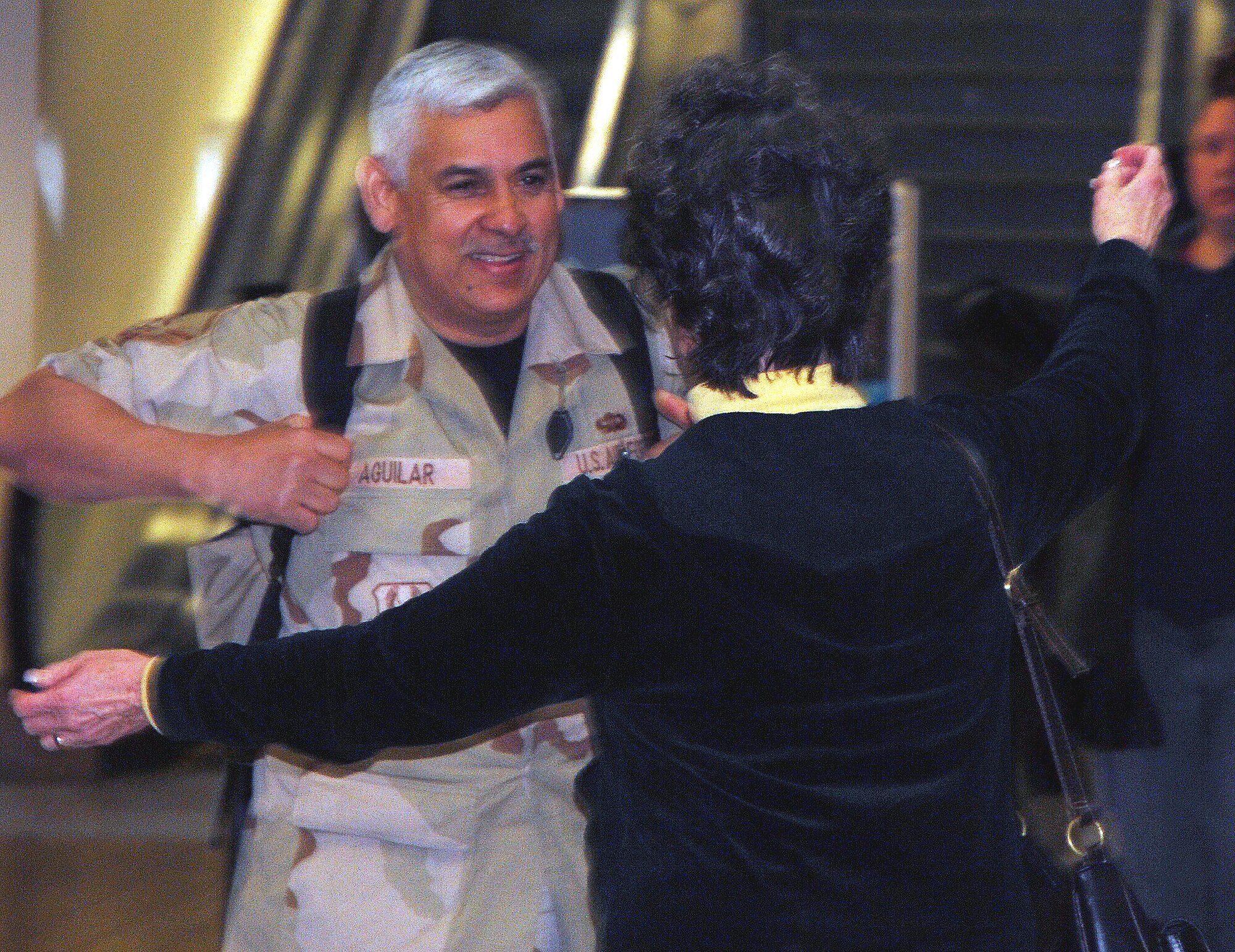 Air Force Reservist Master Sgt. Hector N. Aguilar is welcomed home after a year long deployment. Sergeant Aguilar, a transportation specialist assigned to the 940th Logistics Readiness Squadron, Beale Air Force Base, Calif., volunteered to extend his tour of duty at Manas Air Base, in Kyrgyzstan, a former Soviet republic in Central Asia. He and three other deployed 940th LRS Reservists arrived at Sacramento International Airport Feb. 18, 2008. (U.S. Air Force photo/Master Sgt. Ellen L. Hatfield)