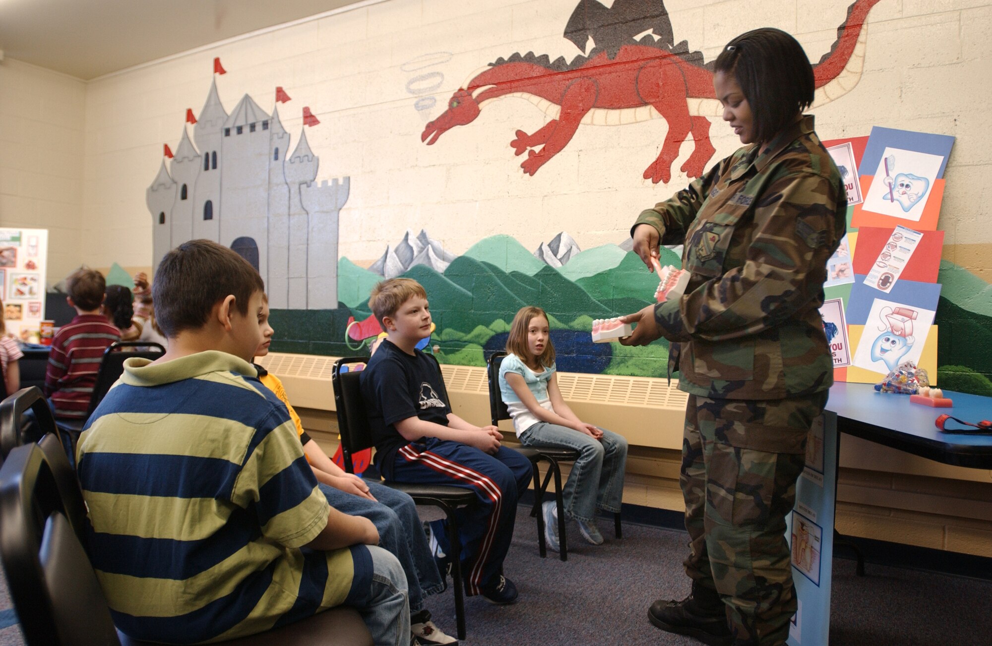 EIELSON AIR FORCE BASE, Alaska --Senior Airman Meshiek Lango, 354th Medical Group dental technician, shows students of Anderson Elementary School the proper way to brush and take care of teeth Feb. 20, 2008, at the school. With February being National Dental Health Month, Icemen of the 354th Medical Group dental office do their part by visiting students of Anderson Elementary to share knowledge on how to maintain their bright smiles. (U.S. Air Force photo by Airman 1st Class Christopher Griffin) 