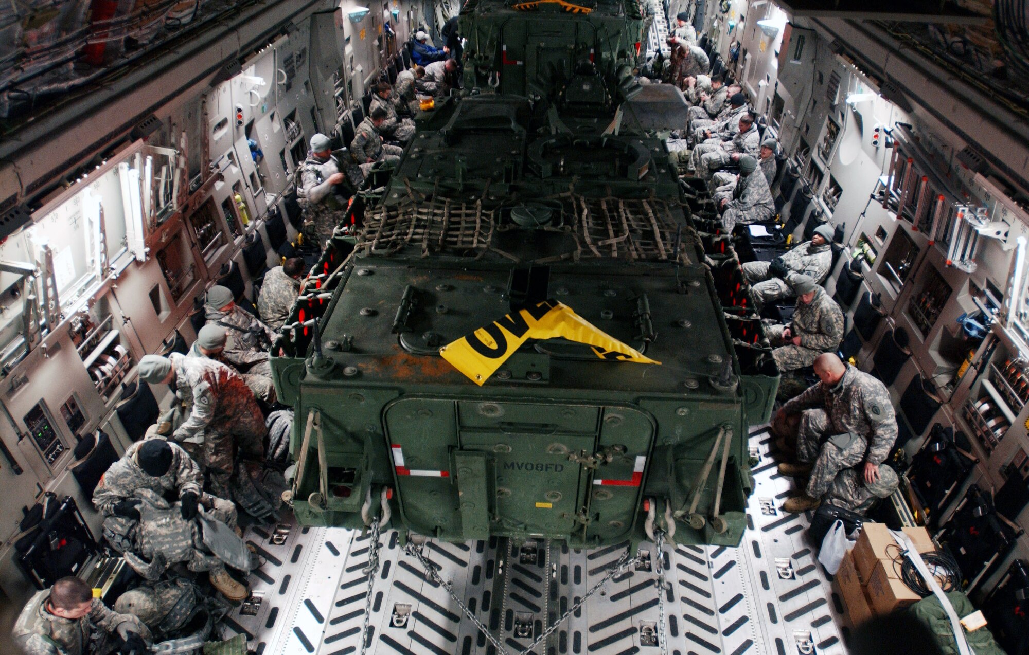 Soldiers from the Army's First Stryker Brigade at Fort Wainwright, Alaska, prepare for departure aboard a C-17 Globemaster III at Eielson Air Force Base, Alaska, that will transport them and their equipment, including two Stryker vehicles, to South Korea in support of a Foal Eagle exercise.  The C-17 and its crew are from the 517th Airlift Squadron at Elmendorf AFB, Alaska. (U.S. Air Force photo/Staff Sgt. Eric T. Sheler)