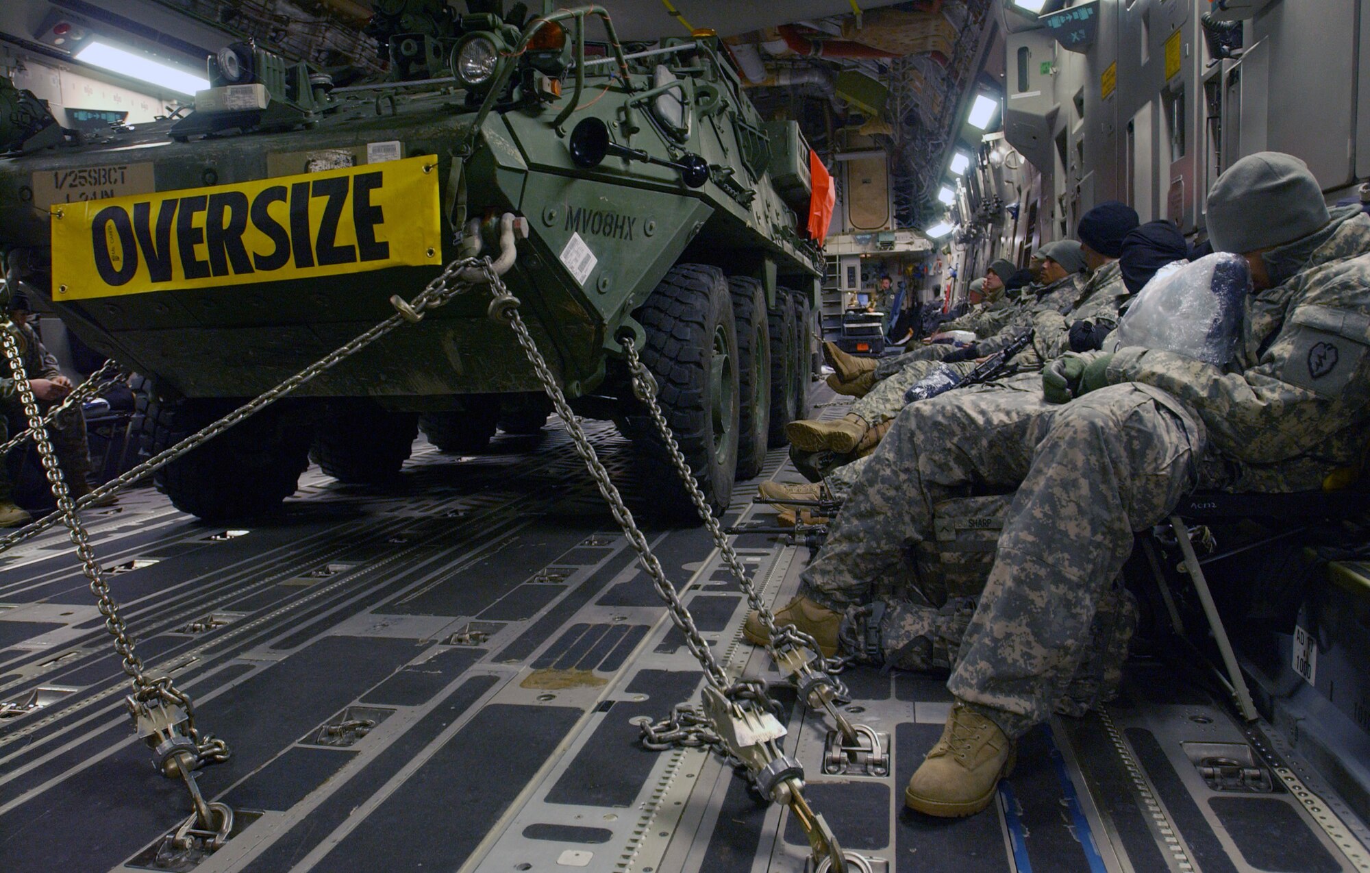 Soldiers from the Army's First Stryker Brigade at Fort Wainwright, Alaska, await takeoff alongside their Stryker vehicle after boarding a C-17 Globemaster III at Eielson Air Force Base, Alaska, that will transport them and their equipment to South Korea in support of a Foal Eagle exercise.  The C-17 and its crew are from the 517th Airlift Squadron at Elmendorf AFB, Alaska. (U.S. Air Force photo/Staff Sgt. Eric T. Sheler)
