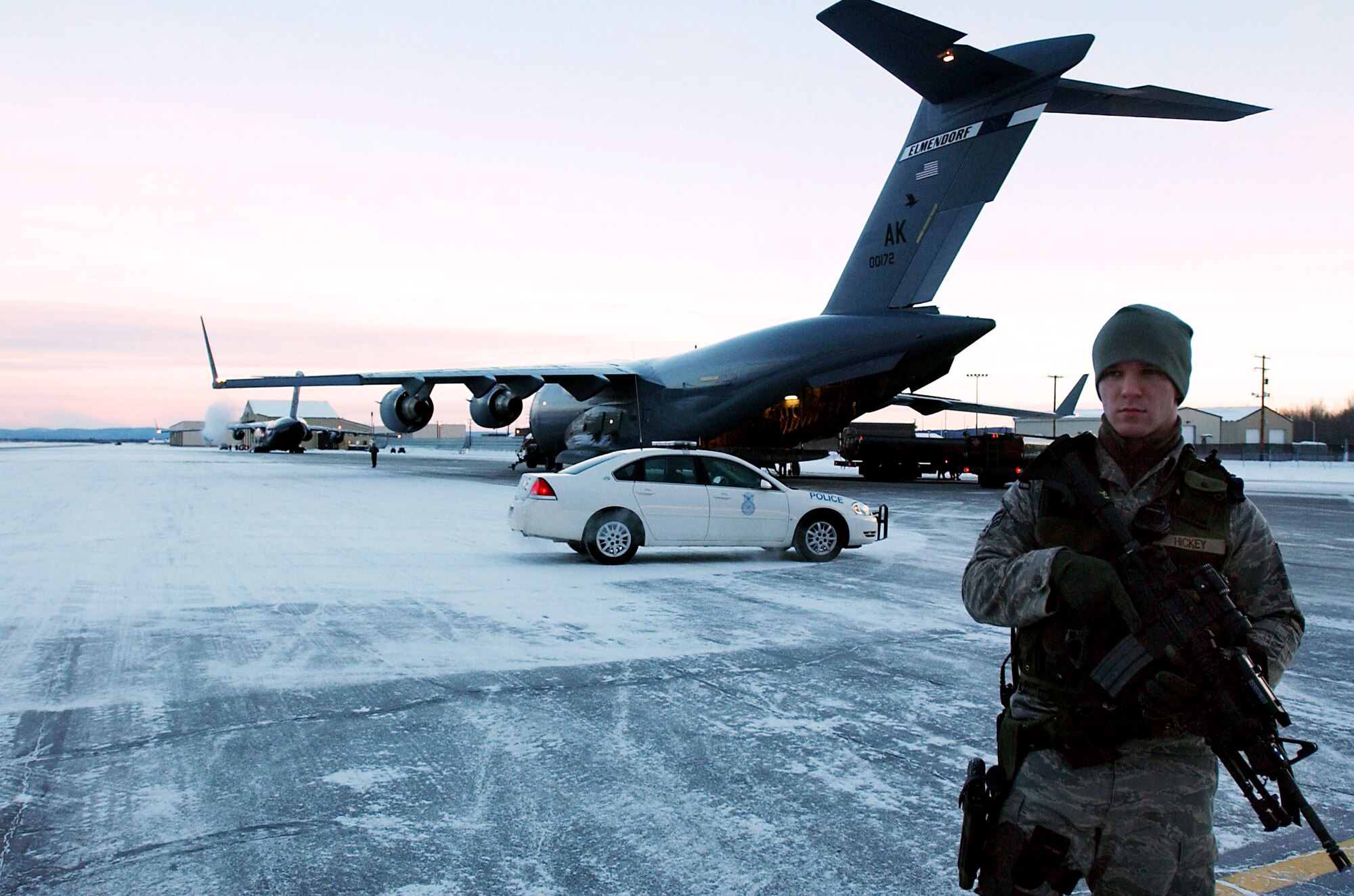 Senior Airman Brad Hickey stands guard in below-zero temperatures, providing security for a C-17 Globemaster III on the ramp at Eielson Air Force Base, Alaska, that is scheduled to transport Soldiers and equipment from the Army's First Stryker Brigade at Fort Wainwright, Alaska, to South Korea in support of a Foal Eagle exercise.  Airman Hickey is with the 354th Security Forces Squadron at Eielson.  The C-17 and its crew are from the 517th Airlift Squadron, Elmendorf AFB, Alaska. (U.S. Air Force photo/Staff Sgt. Eric T. Sheler)