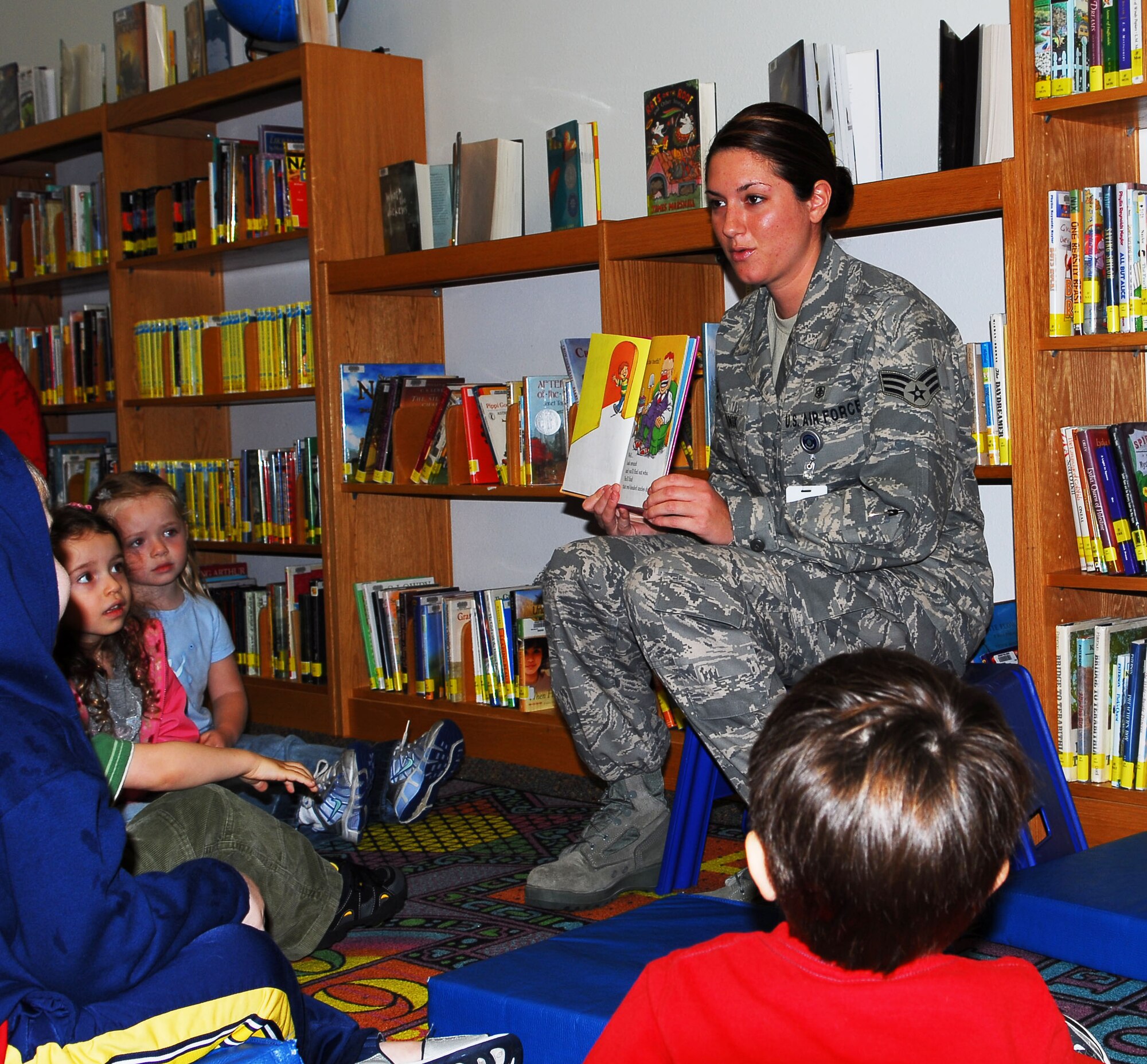 Senior Airman Kristen Zemanik, 1st Special Operations Dental Squadron, reads Dr. Seuss' "The Tooth Book" to a group of children Feb. 21 at the Hurlburt Field Library. The storytelling session was one of several events sponsored by the 1st SODS in support of National Children's Dental Health Month with the goal of teaching children proper dental hygiene habits. (U.S. Air Force photo/Airman 1st Class Sheila DeVera)