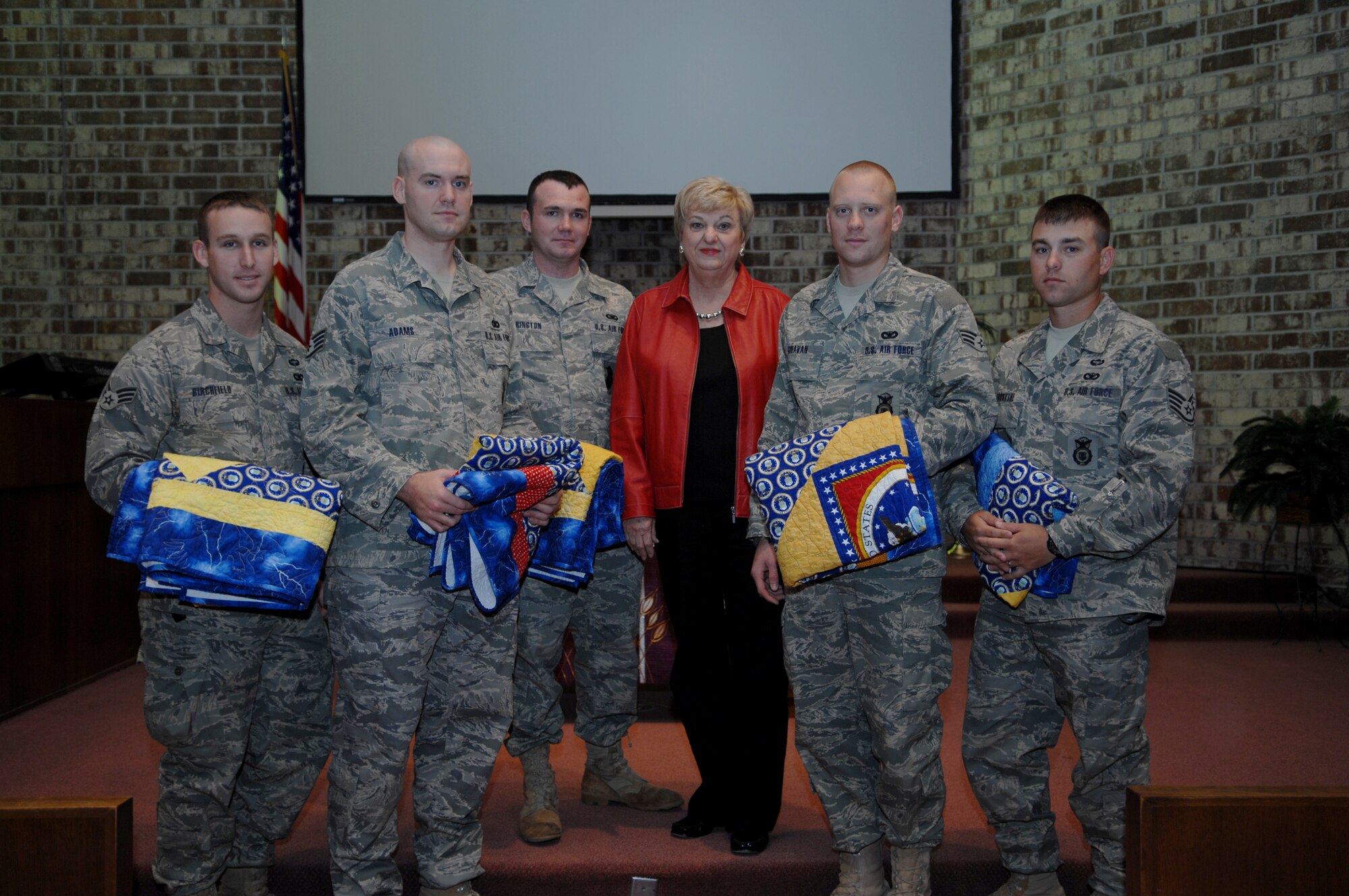 MOODY AIR FORCE BASE, Ga. – Airmen from the 820th Security Forces Group pose for a group photo with Jane Knight, a local member of the Quilts of Valor Foundation, Feb. 20 here.  Ms. Knight and the QOV foundation presented quilts to the Airmen after they were wounded while deployed in support of Operation Iraqi Freedom. The Quilts of Valor Foundation began in 2003 and consists of volunteers from around the United States who help make quilts for injured servicemembers. Since its inception, the foundation has presented more than 15,000 quilts to wounded military members. (U.S. Air Force photo by Senior Airman Angelita Lawrence)