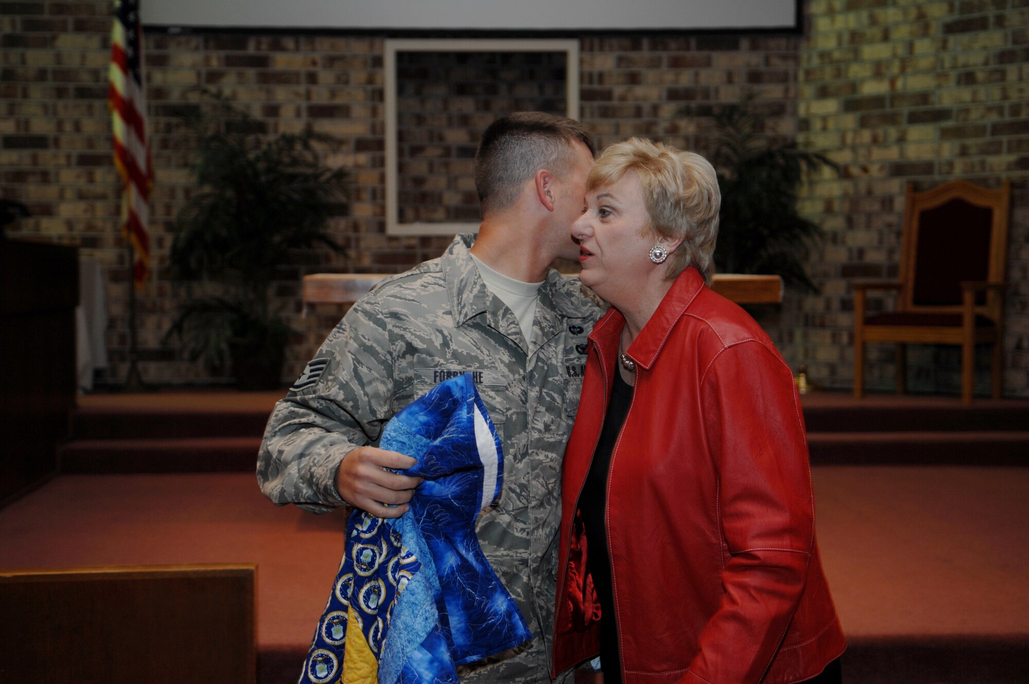 MOODY AIR FORCE BASE, Ga. – Staff Sgt. Stephen Forsythe, 824th Security Forces Squadron, gives Jane Knight, a member of the Quilts of Valor Foundation, a hug Feb. 20 here.  Ms. Knight presented five quilts to 820th Security Forces Group Airmen who were wounded in Iraq. (U.S. Air Force photo by Senior Airman Angelita Lawrence)